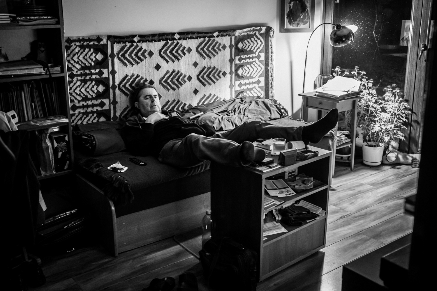 Wojtek resting on a sofa in his living room