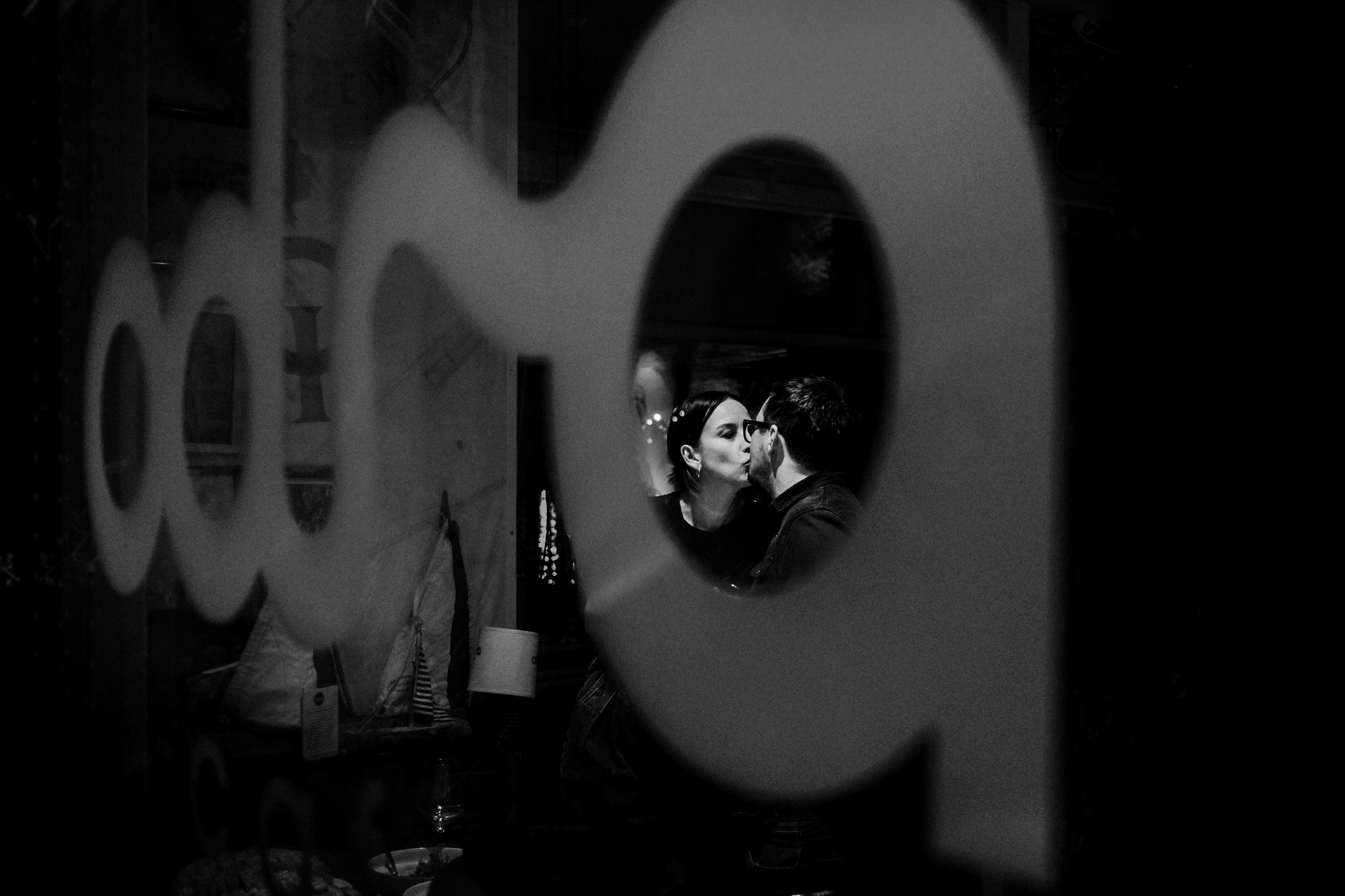 Couple reflected in a shop window during a quiet moment together, from the project Intimacy
