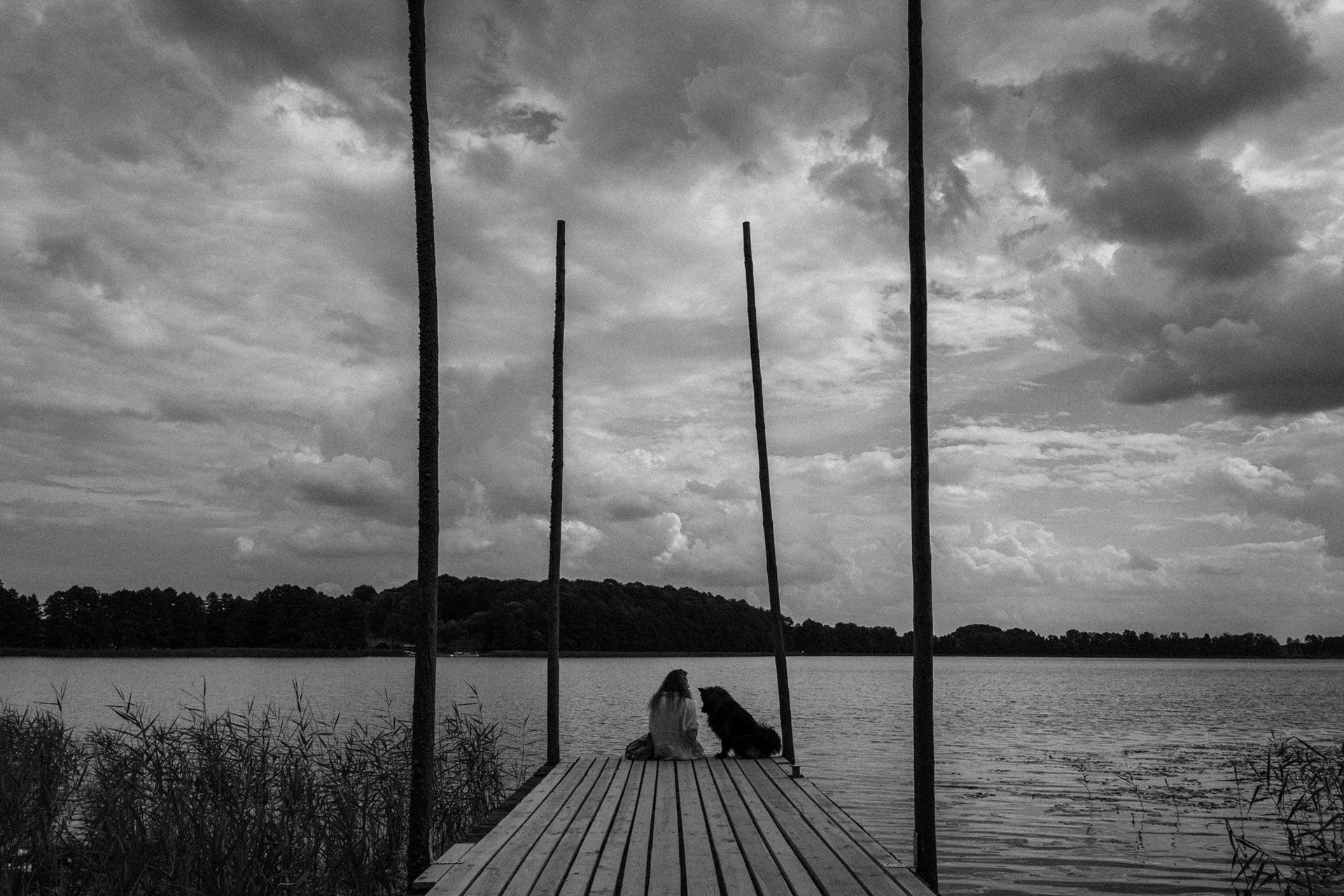 Couple sitting together on a wooden pier by the lake, from the project Intimacy