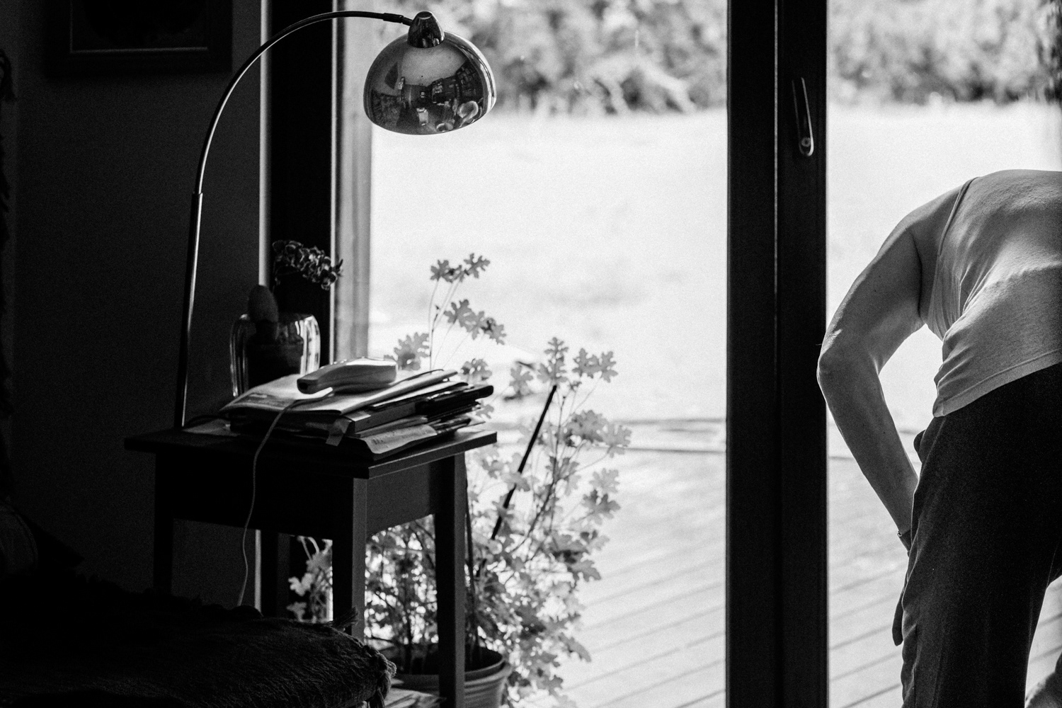 Portrait of Wojtek standing by a window in his home, from the project Zeus by documentary photographer Sebastian Szczepanowski.