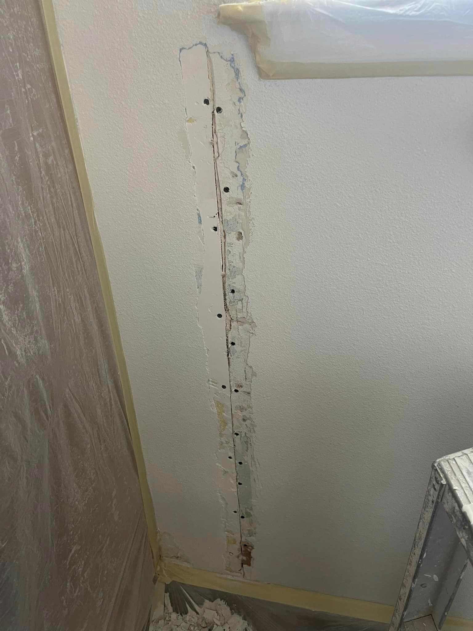 Cracked taped removed with new drywall screws to reinforce the drywall