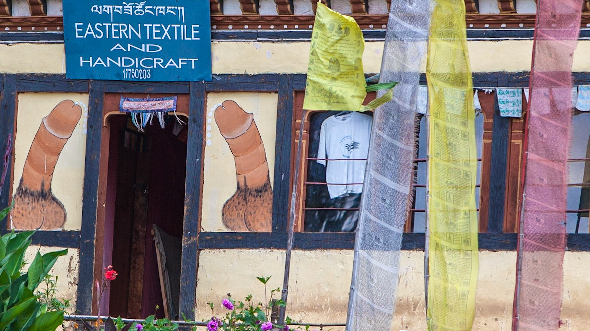 Prayer flags and painting in Buthan. Fallic pictures are common in Buthan