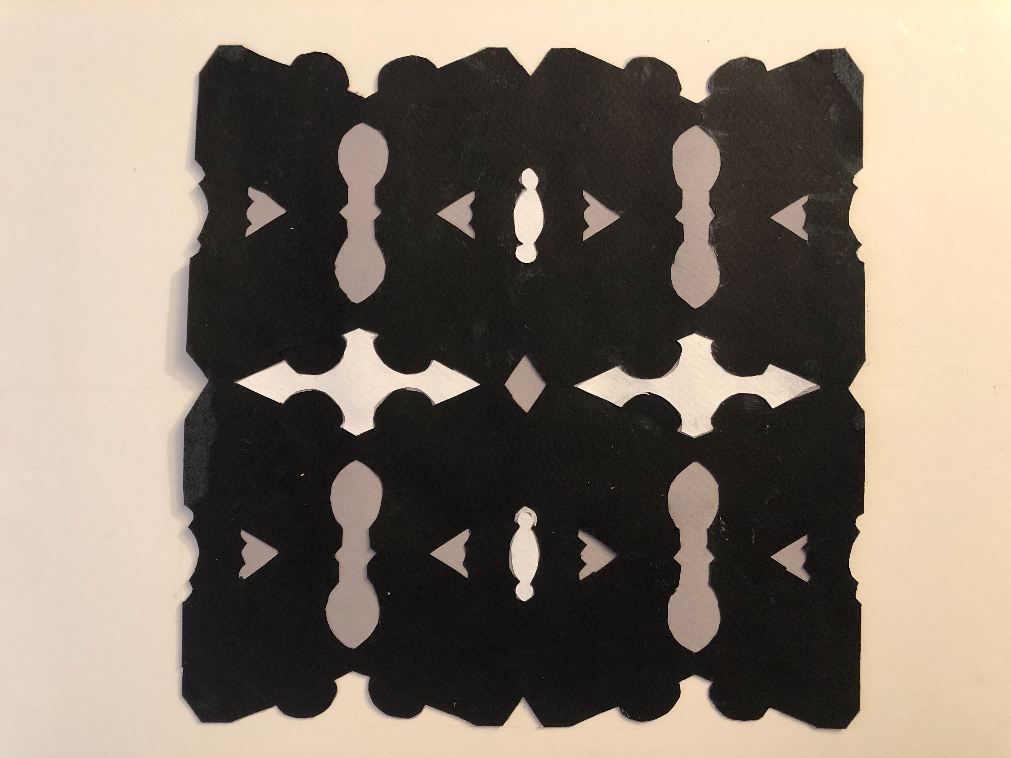 The motif of the lamp. The negative spaces were put into Adobe Illustrator and arranged into random shapes and positions.