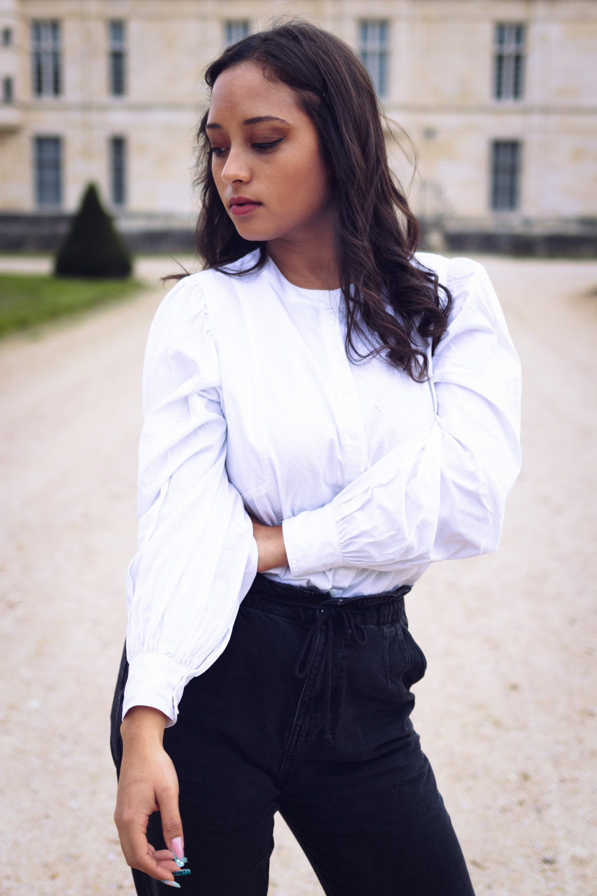 Portrait de mode d-une jeune femme devant un chateau d-Ile-de-France