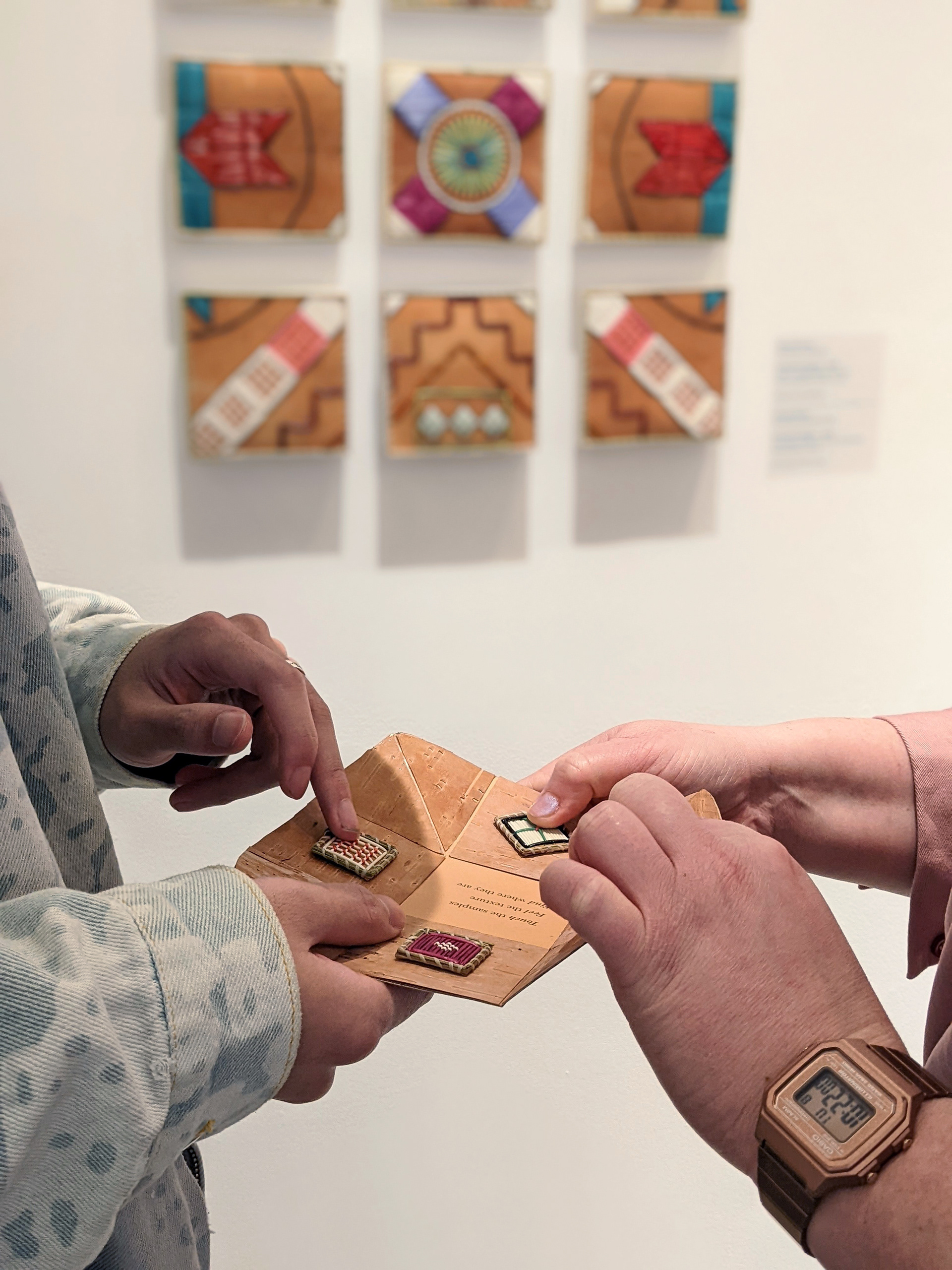 Visitors feeling the quillwork samples