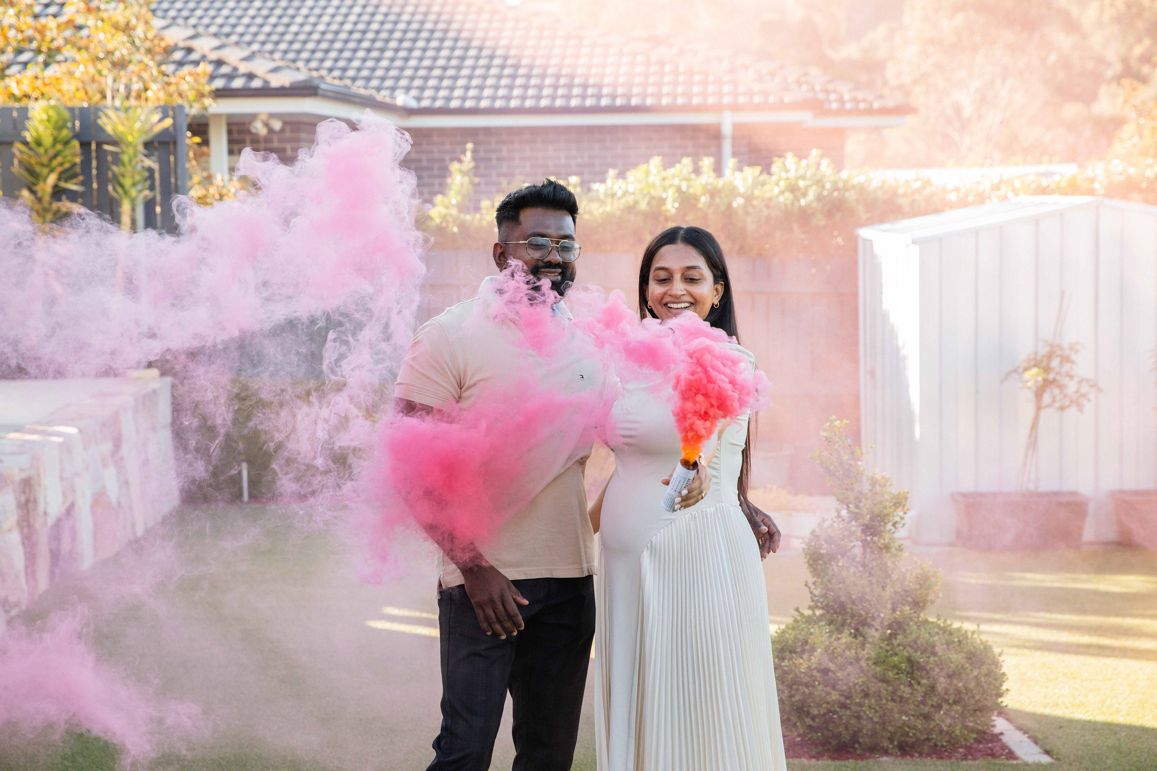 Couple celebrating baby’s gender in an outdoor Canberra photoshoot by Olia Photography.