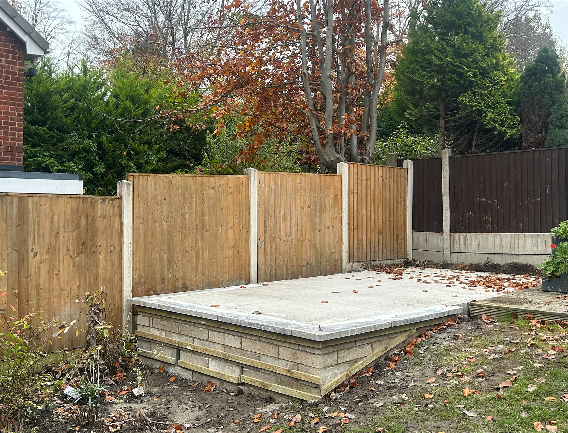 Block retaining wall and concrete slab