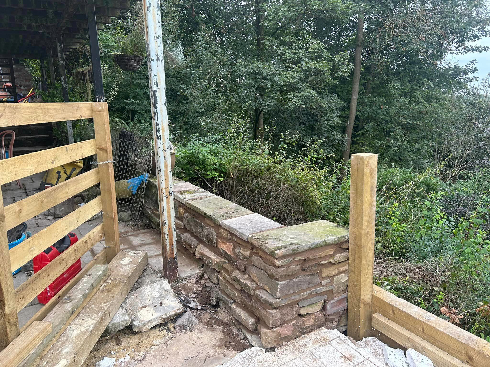 Parapet wall. Gritstone random rubble.