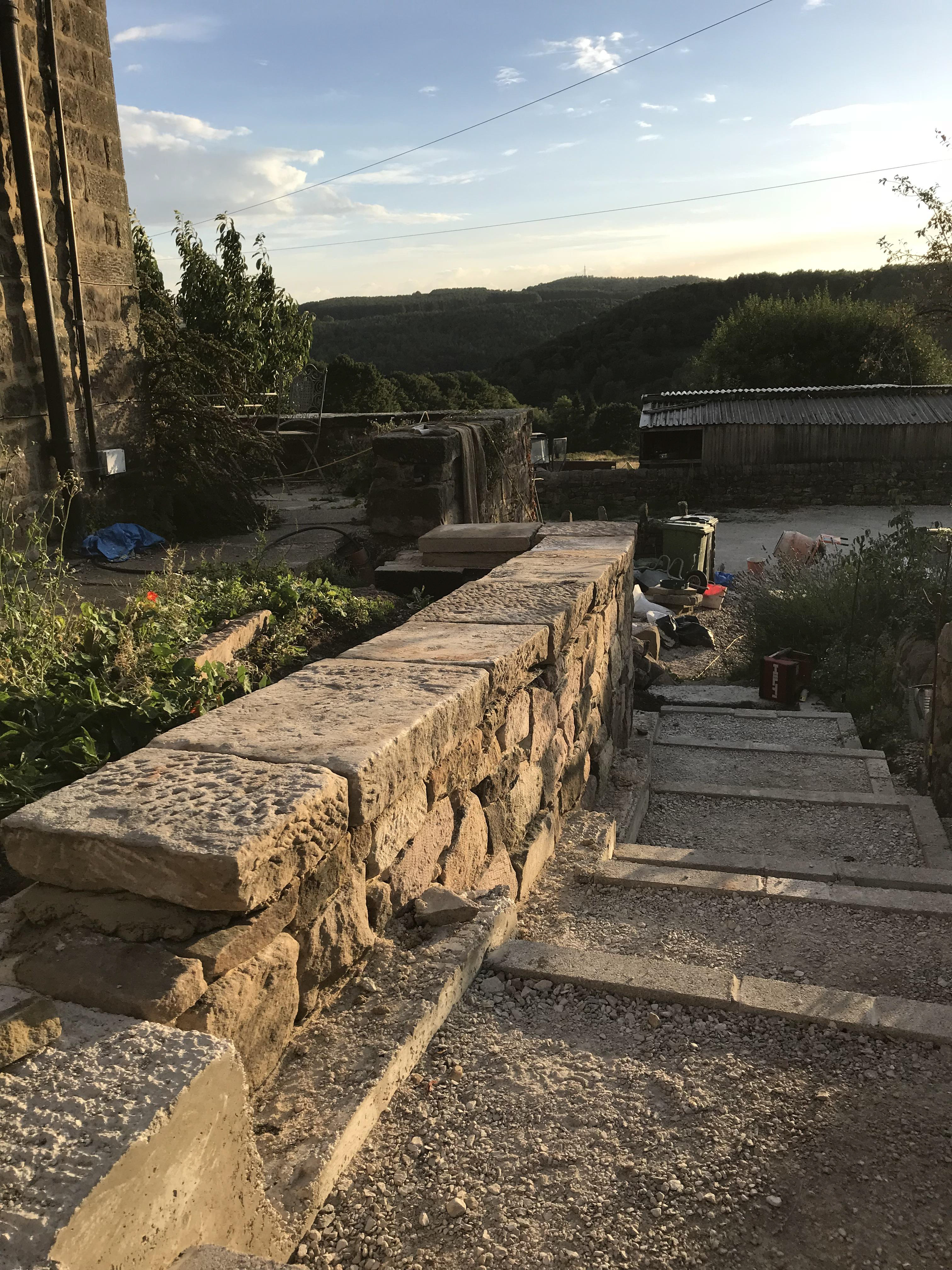 Mortared concrete block and sandstone retaining wall