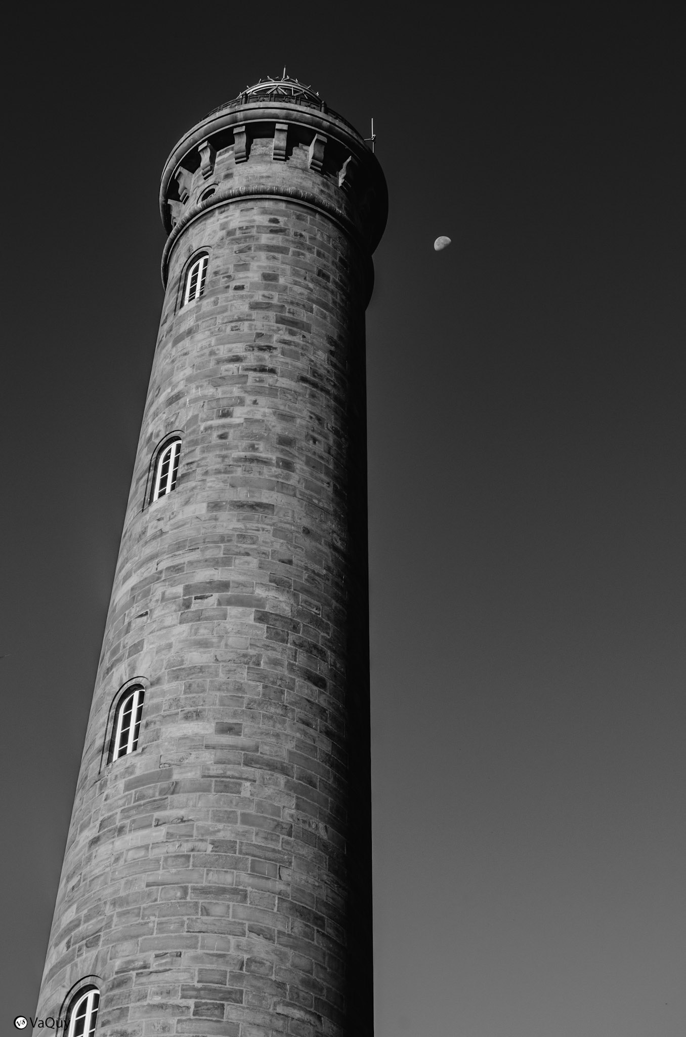 Chipiona lighthouse from Las Canteras beach, against a clear sky.