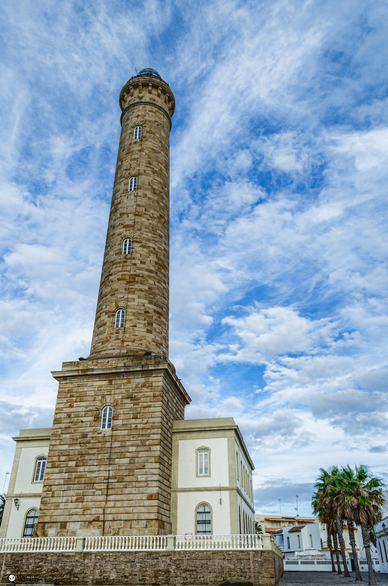 Chipiona lighthouse from Las Canteras beach, against a clear blue sky.