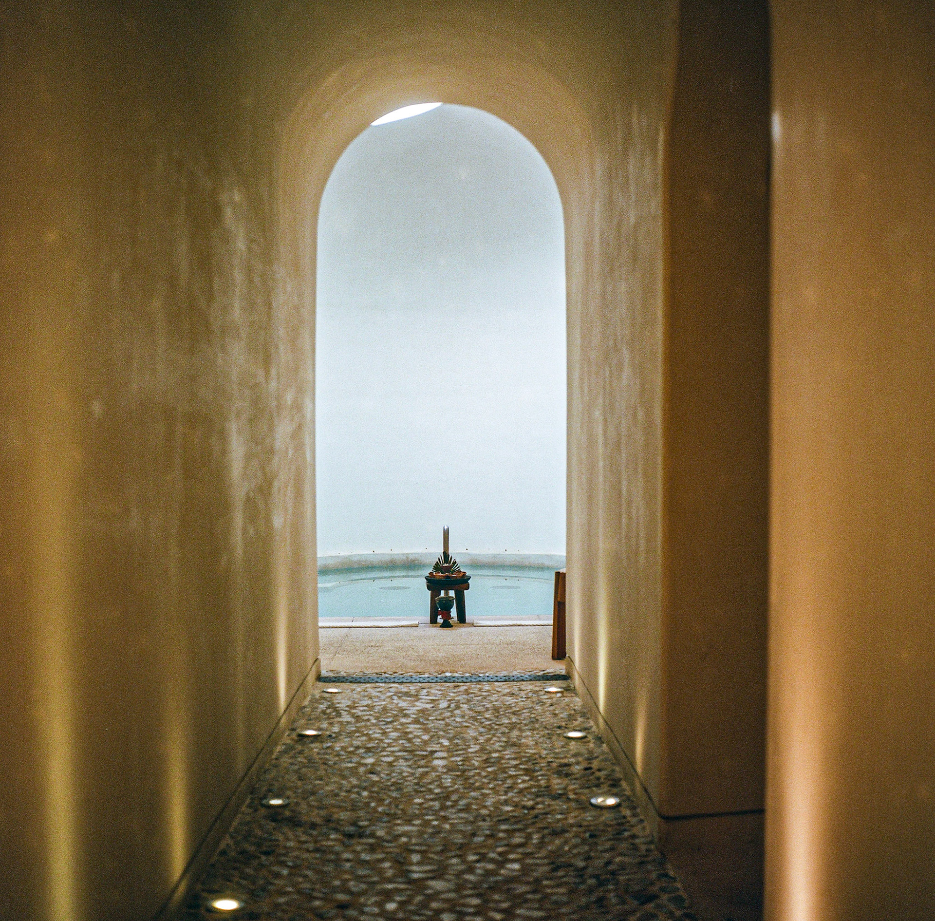 Arched stone corridor at Sana Spa at Etereo, Auberge Collection, framing the dip pool and tranquil architectural light. Explore the full series at dyoon.space.