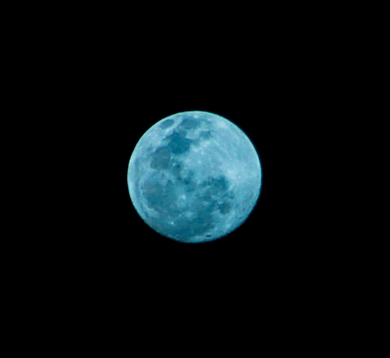 Hand held shot of a very bright full moon taken from a dirt road in Bweogrere Uganda Africa while listening to the goats moan in the "silence" of the night