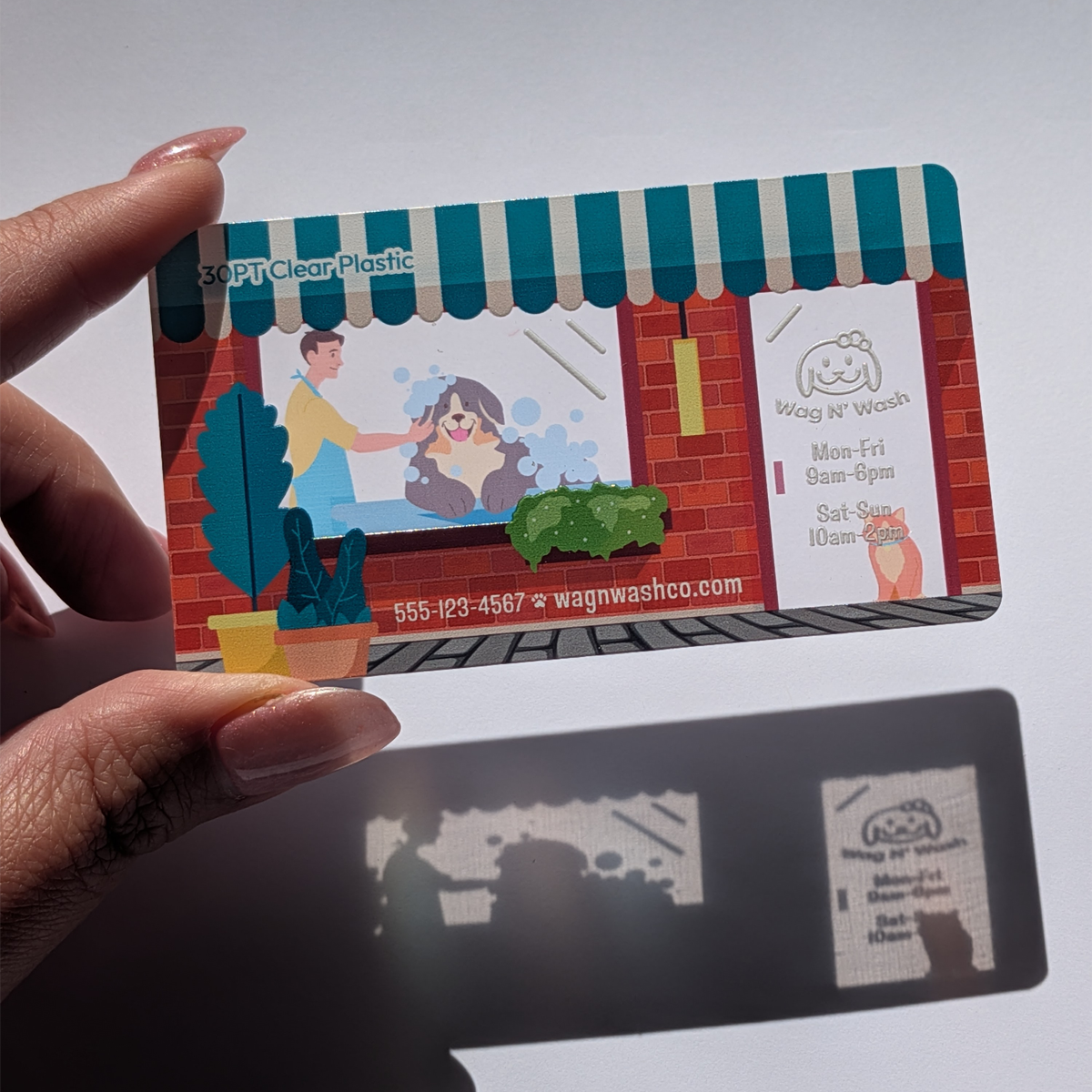 Double-sided printed plastic card utilizing transparency