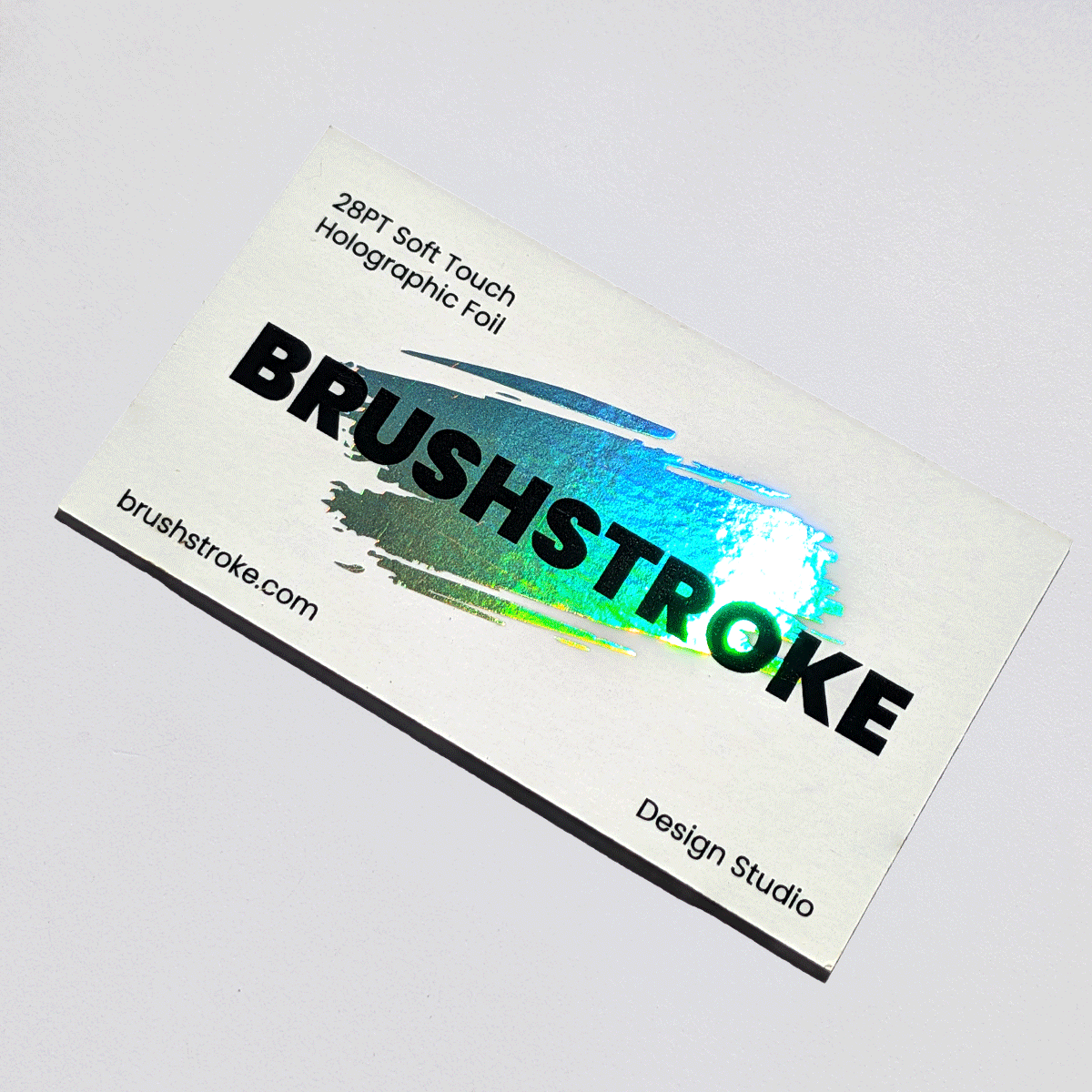 Soft-touch laminated card with layered foil and ink