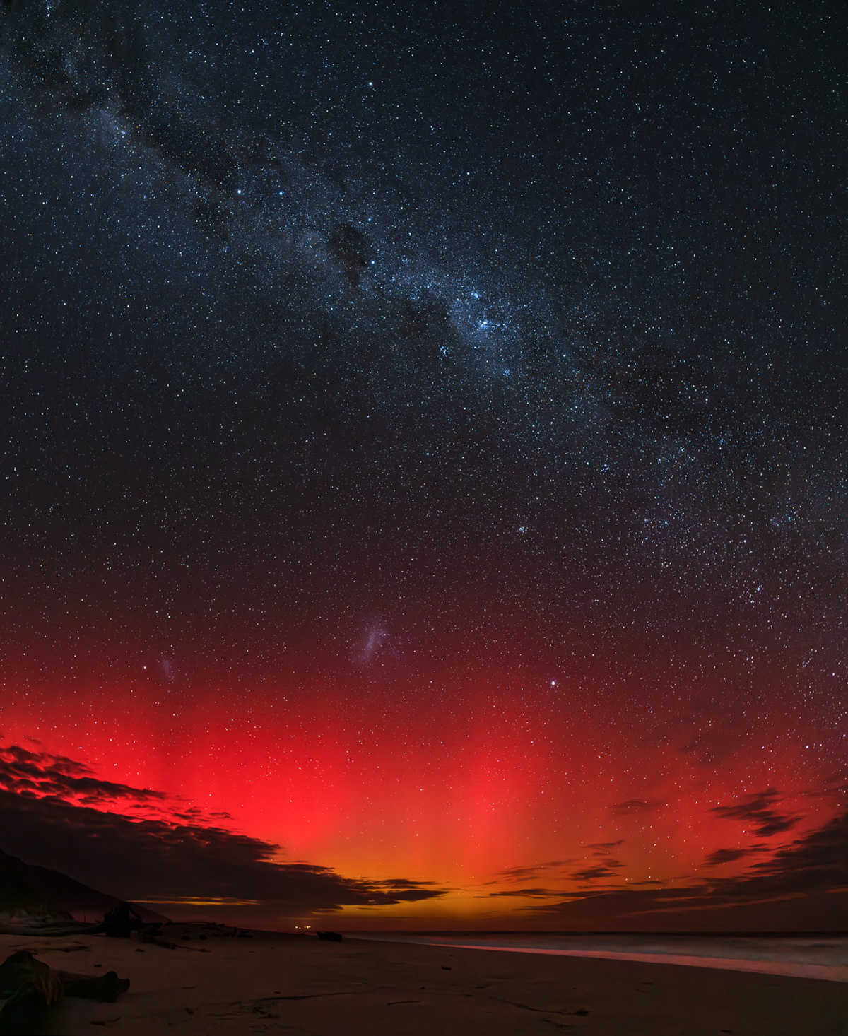 A dark, moonless walk was rewarded with a spectacle: the bright Milk Way arching across the sky, the pounding of surf on the beach, the calls of kiwi and weka, and a red glow of the aurora!