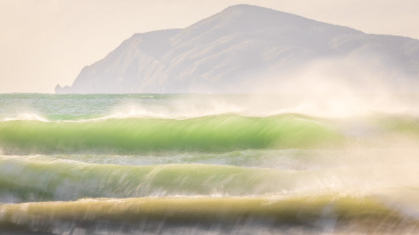 Kāpiti surf: An offshore breeze lifts waves in the late afternoon light