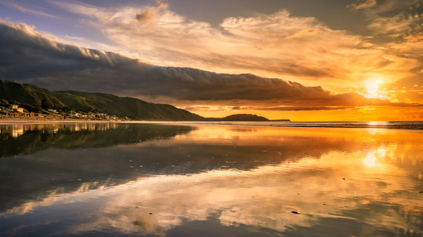 Sunset in Paradise: A bank of clouds hovered over Paekākāriki allowing the golden light to stream in. Low tide provided a nice reflection