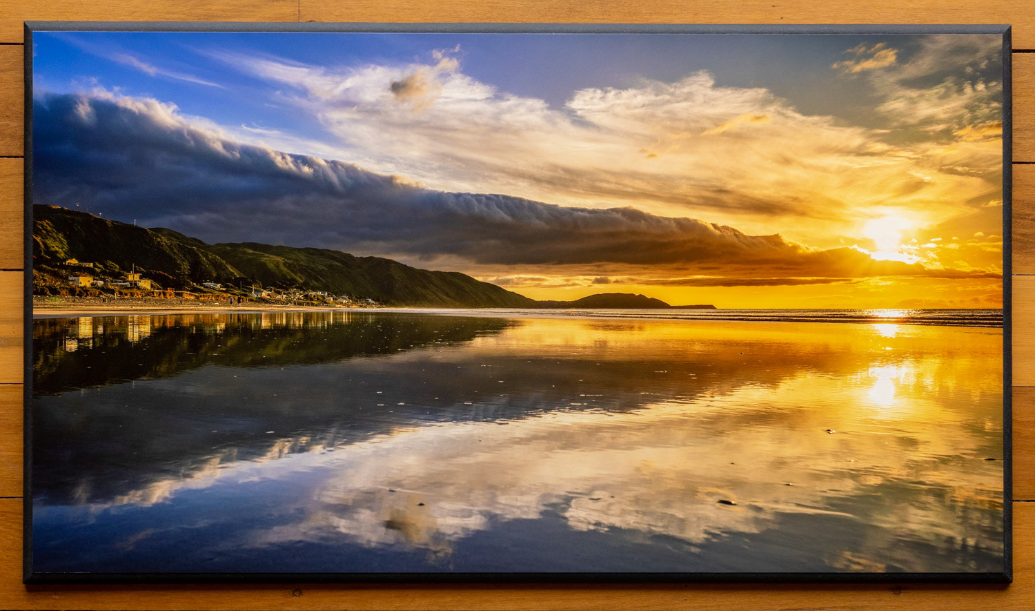 Sunset in Paradise. A bank of clouds hovered over Paekakariki allowing the golden light to stream in. Low tide provided a nice reflection.
