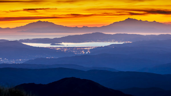 View from Kime Hut: A unique view of the Hutt Valley, Wellington and its harbour, and Tapuae-o-Uenuku and Manakau in the South Island. You can even see the Kaikoura Peninsula!