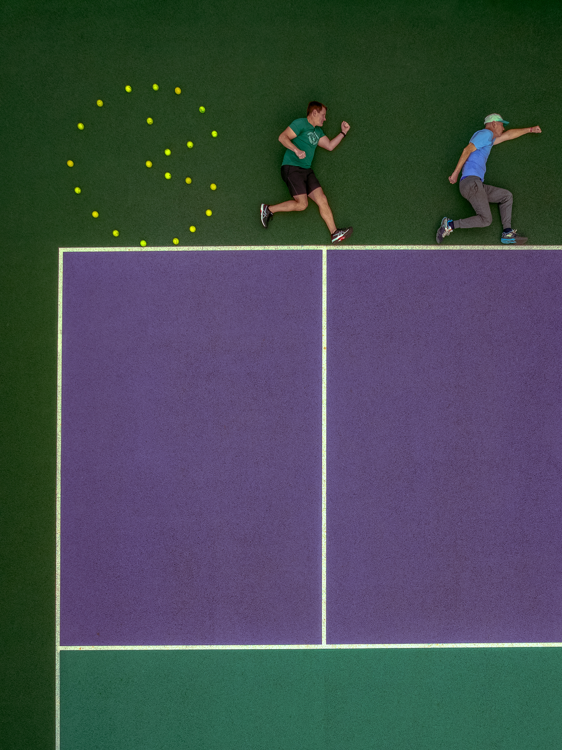 Top-down creative aerial photography print of  two Pickball players running from PACMAN