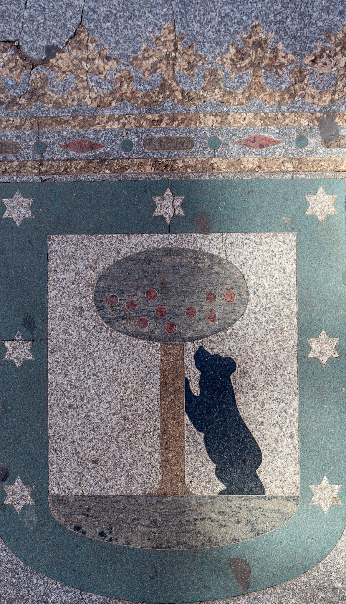 The Bear and the Strawberry Tree emblem in the pavement, Madrid, 2018