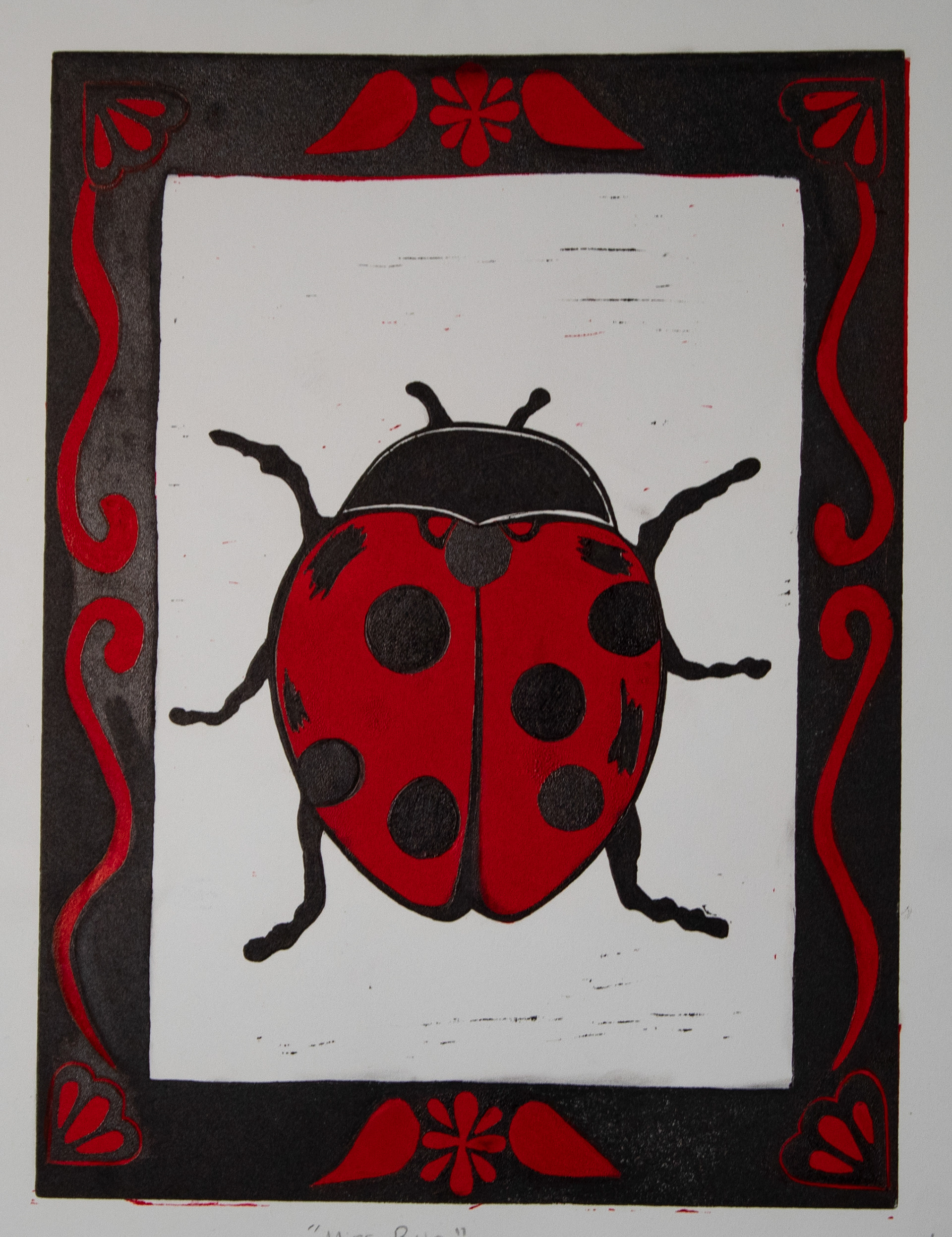 "Miss Bug", Printmaking,  11 x 14, 2025 |  This piece is a two-block linoleum print that implements the use of a carved frame. Ladybugs have always been a large symbol in my life, and I wanted to create something that reflects that. 