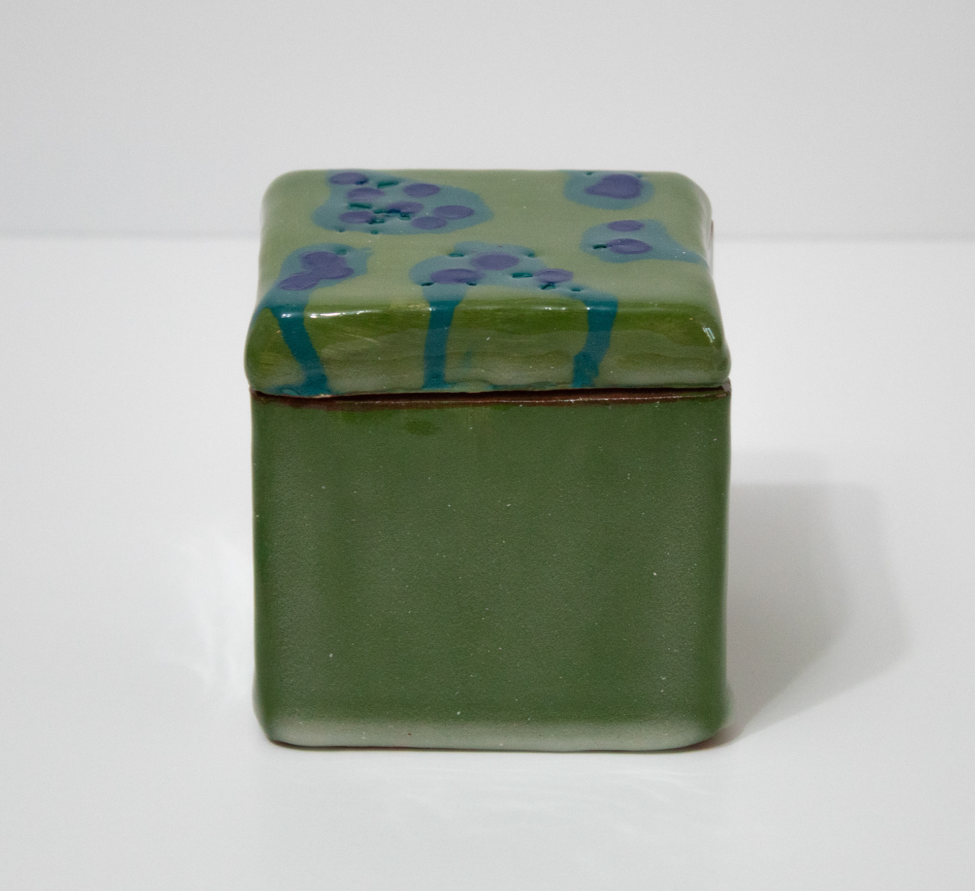 "Untitled", Ceramic, 3.5 x 3.5 x 3.5, 2025 |  This piece is a slab box that is covered in green underglaze. The dots on top were achieved by dripping underglaze on and letting it run off. 