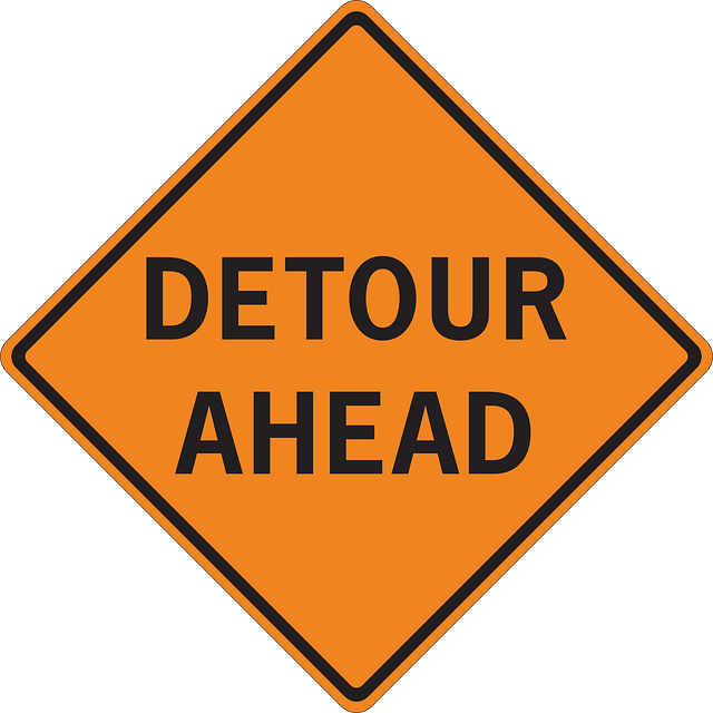 Detour ahead road sign.