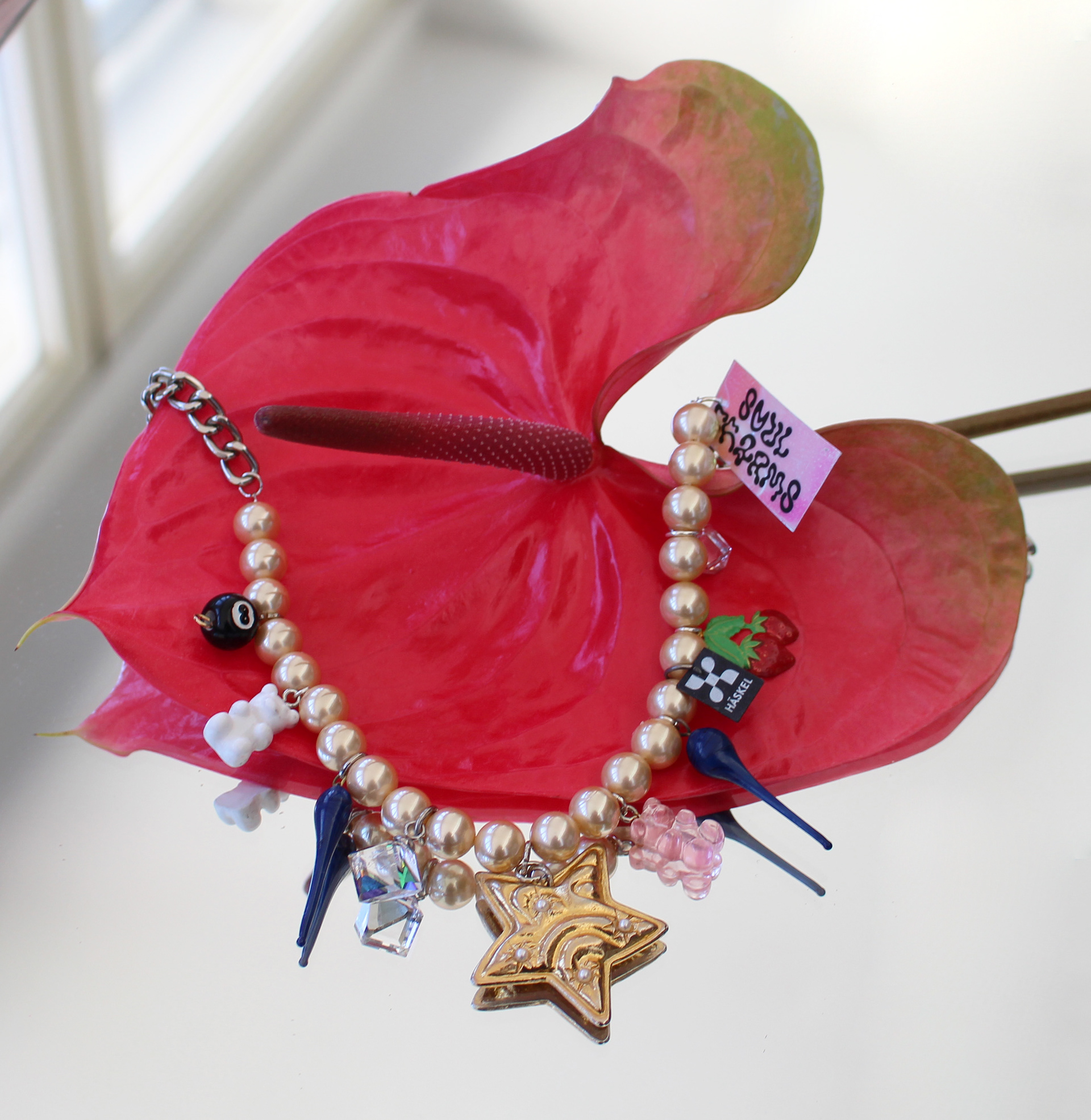 Long choker pearl necklace designed with high quality vintage pearls, Swarovski and other selected charms.