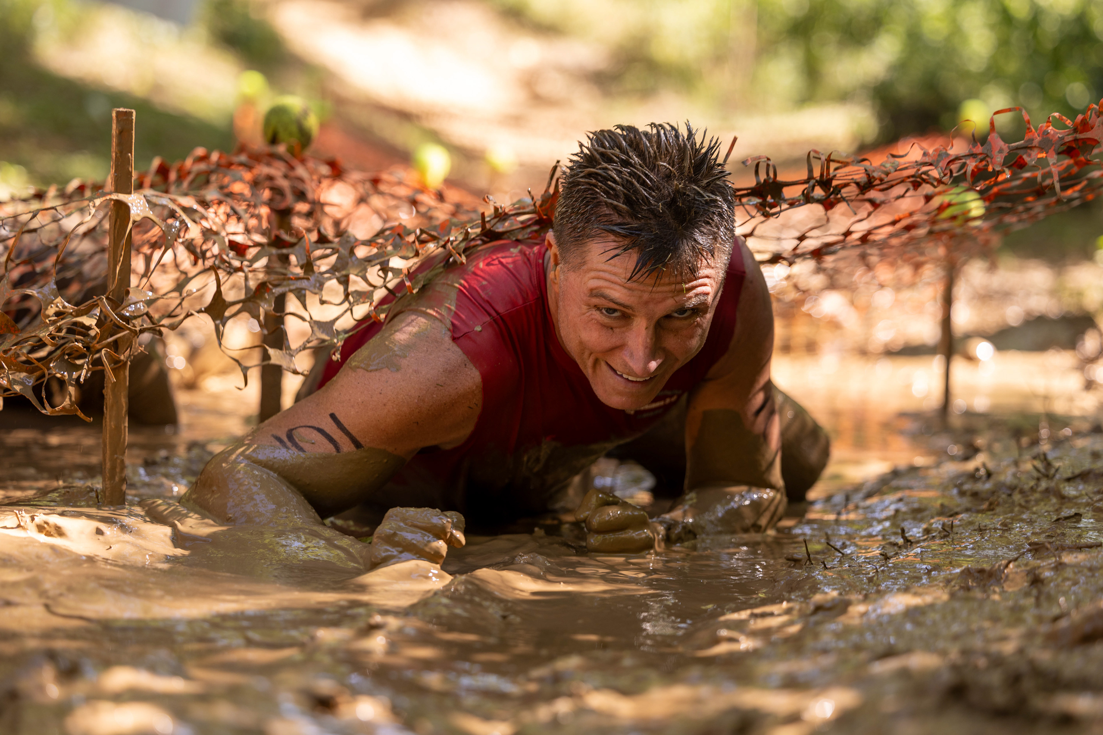 Brent Sanford crawls through the mud at the Pigpen’s Playground obstacle at the Family Enrichment Center’s 14th annual Henkel Mud Happens: One Bad Mud Run at Phil Moore Park on August 29, 2026