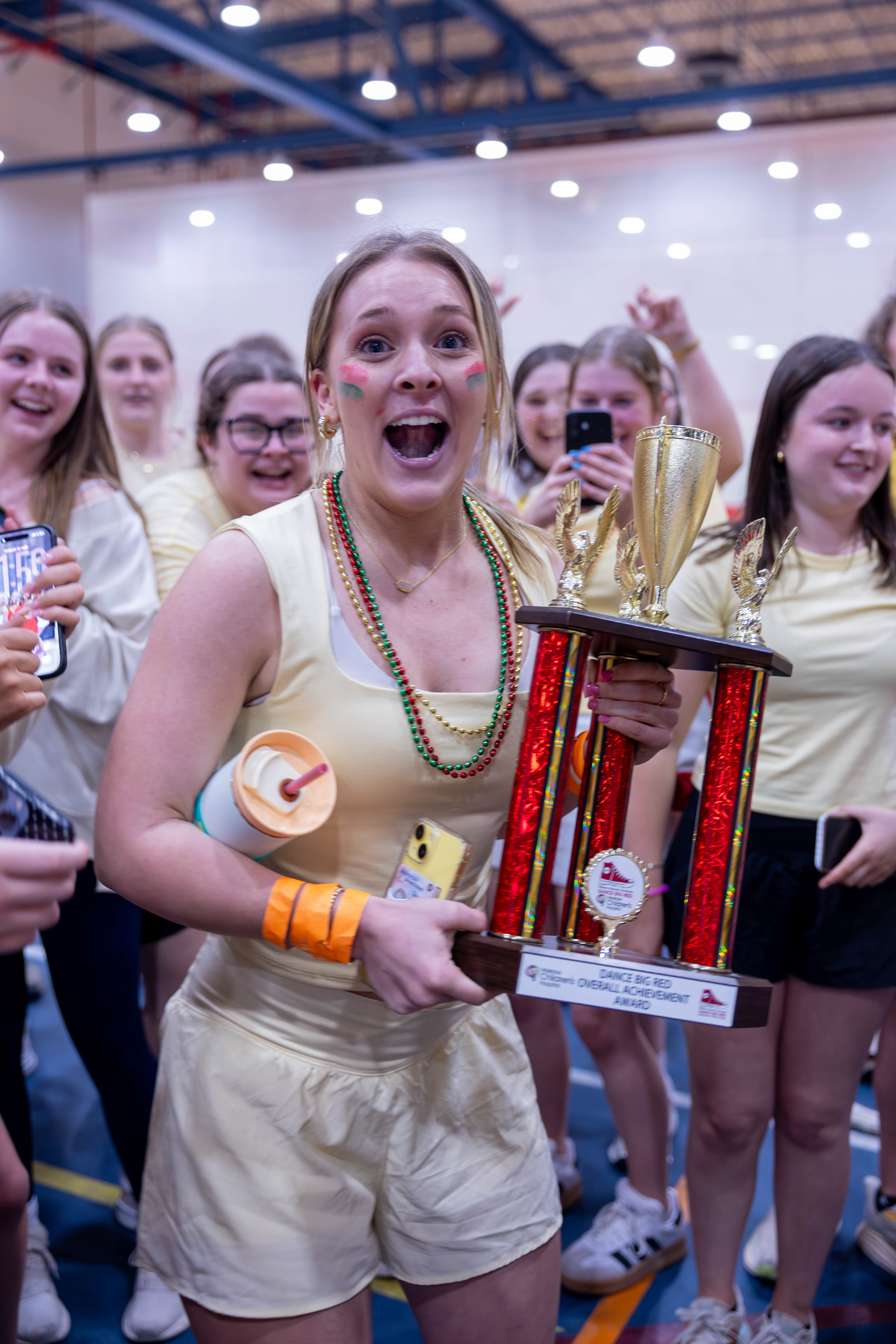 Alpha Delta Gamma sorrority won the highest achievement award at Dance big Red. Abigail Wissing Holds the trophy proud in front of her team on March 6 2026.