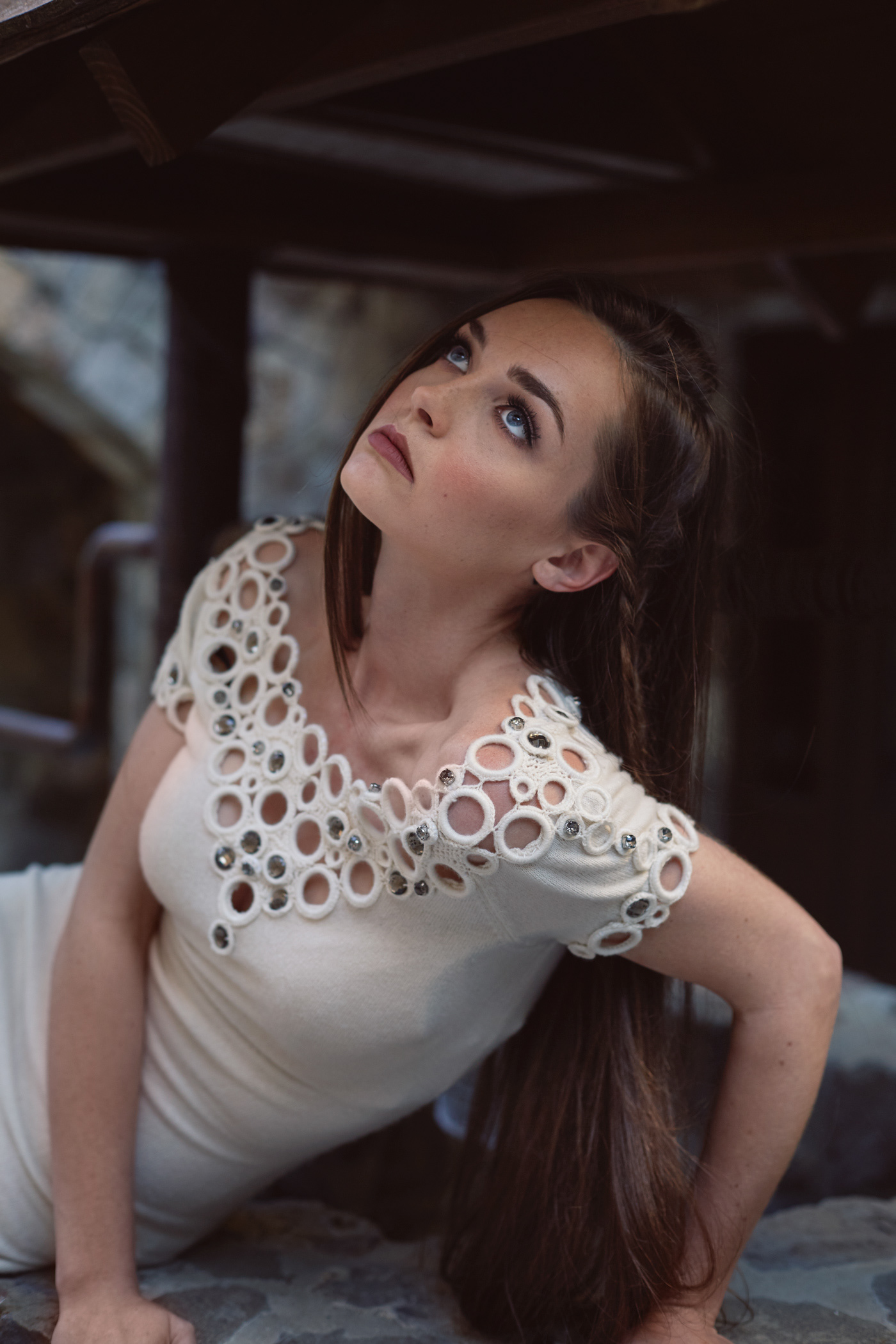 Beautiful girl sitting on well.  Photo by Modern Human