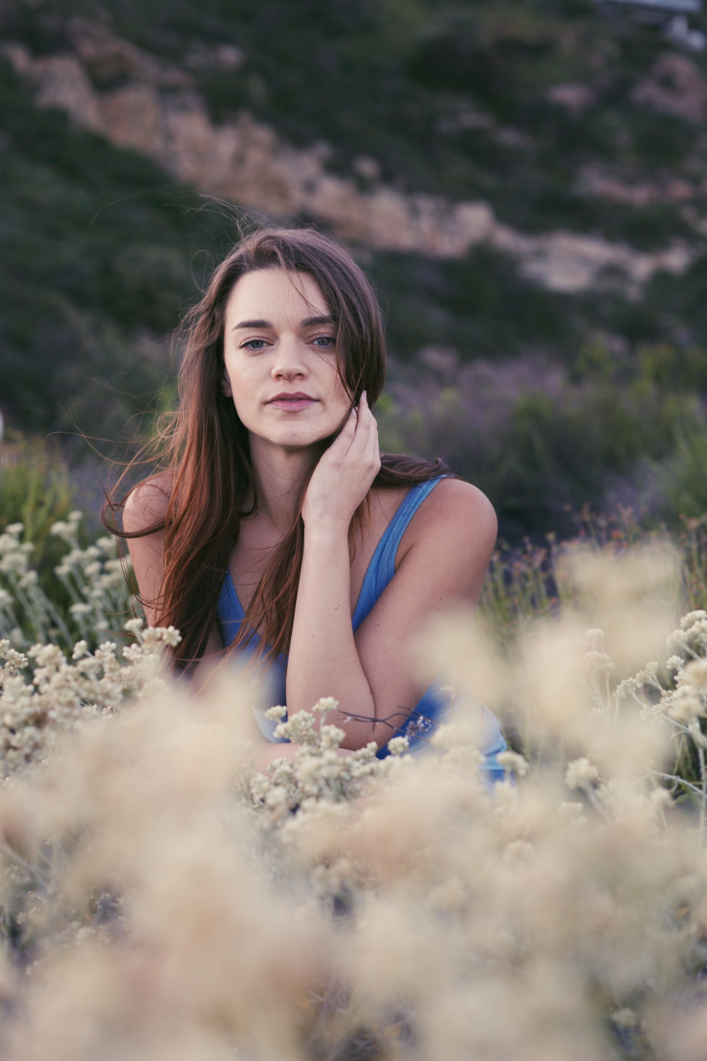 Beautiful woman stares into the camera.  Wind blowing. Photo by Modern Human