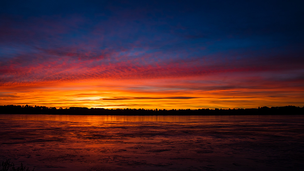 Sunrise over frozen lake