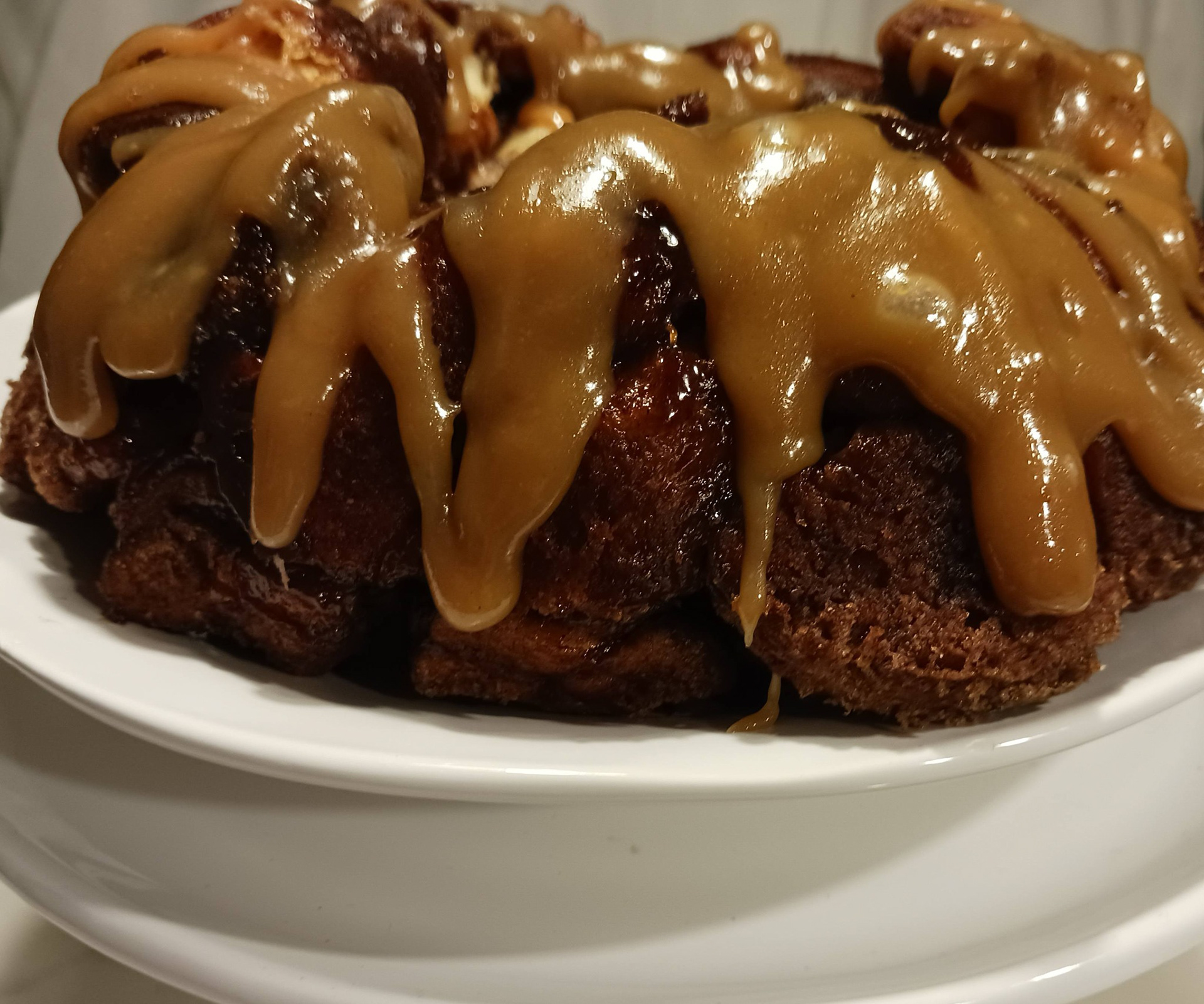 Homemade Caramel Rum Sauce dripped over homemade monkey bread. Can we say SUPER Mmm Mmm GOOD!! This will never disappoint.
