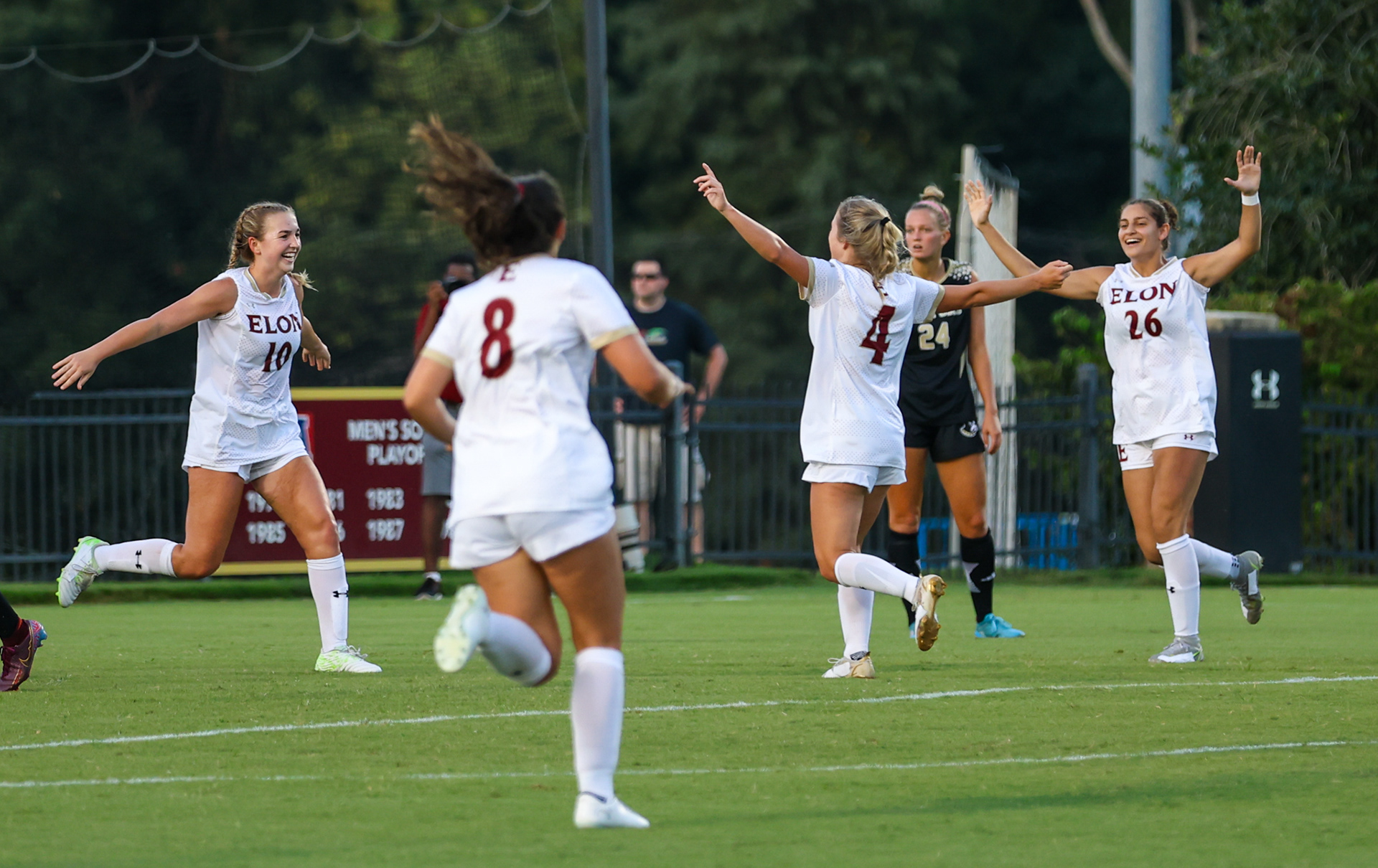 Maya Abousaab (right) celebrates with teammates after Ashlee Brehio scored for Elon on Aug. 20 against Wofford.