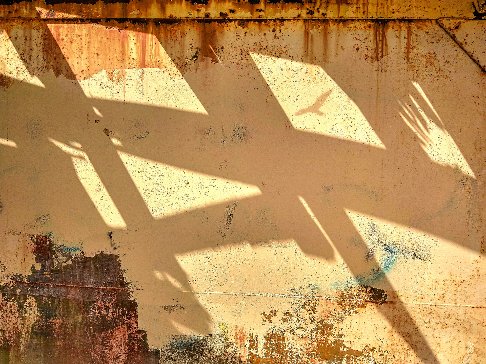 Strong ghostly shadows cast on urban wall.