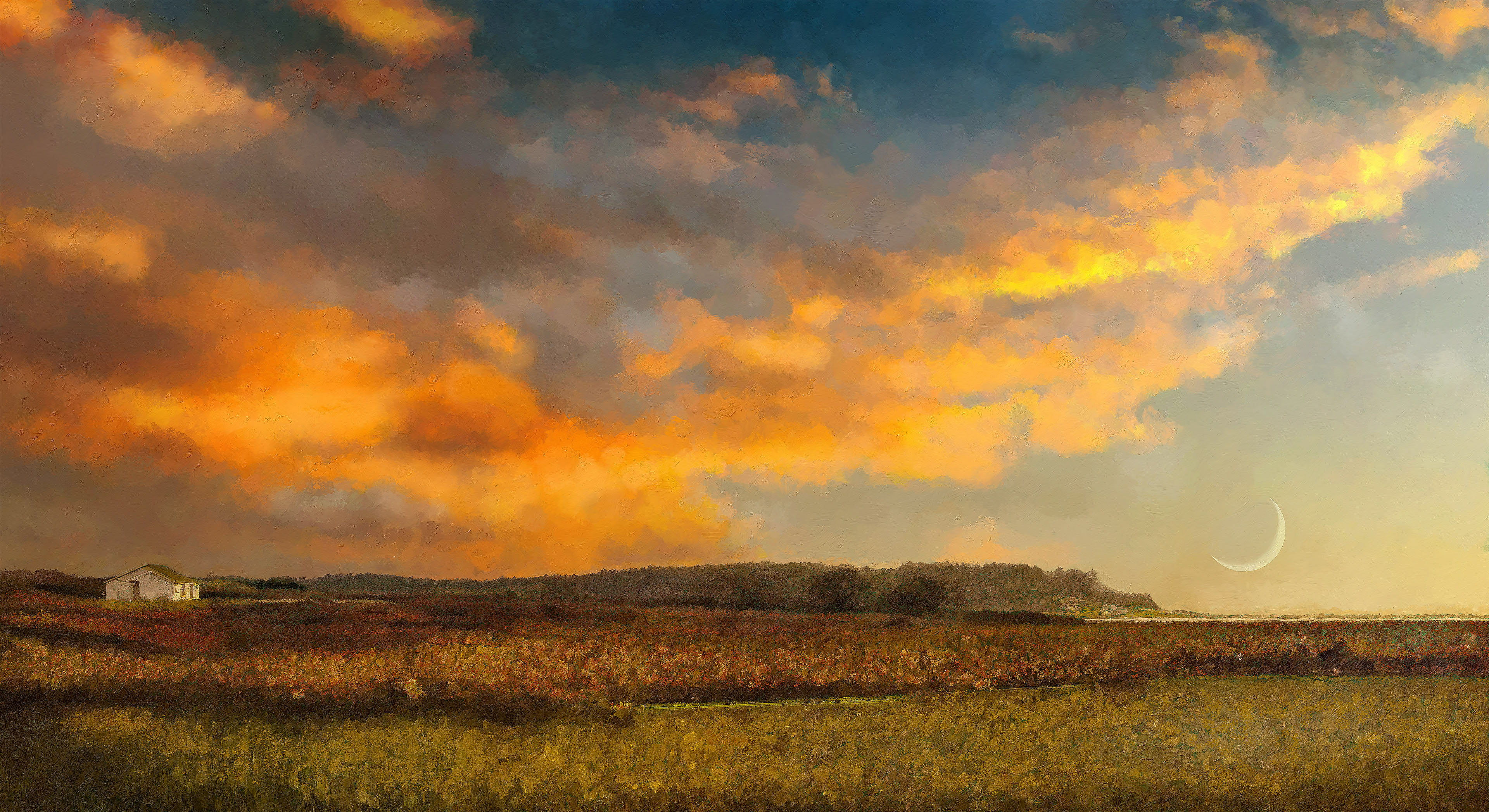 Evening scene over grassy field with a dramatic, colorful sky at sunset.