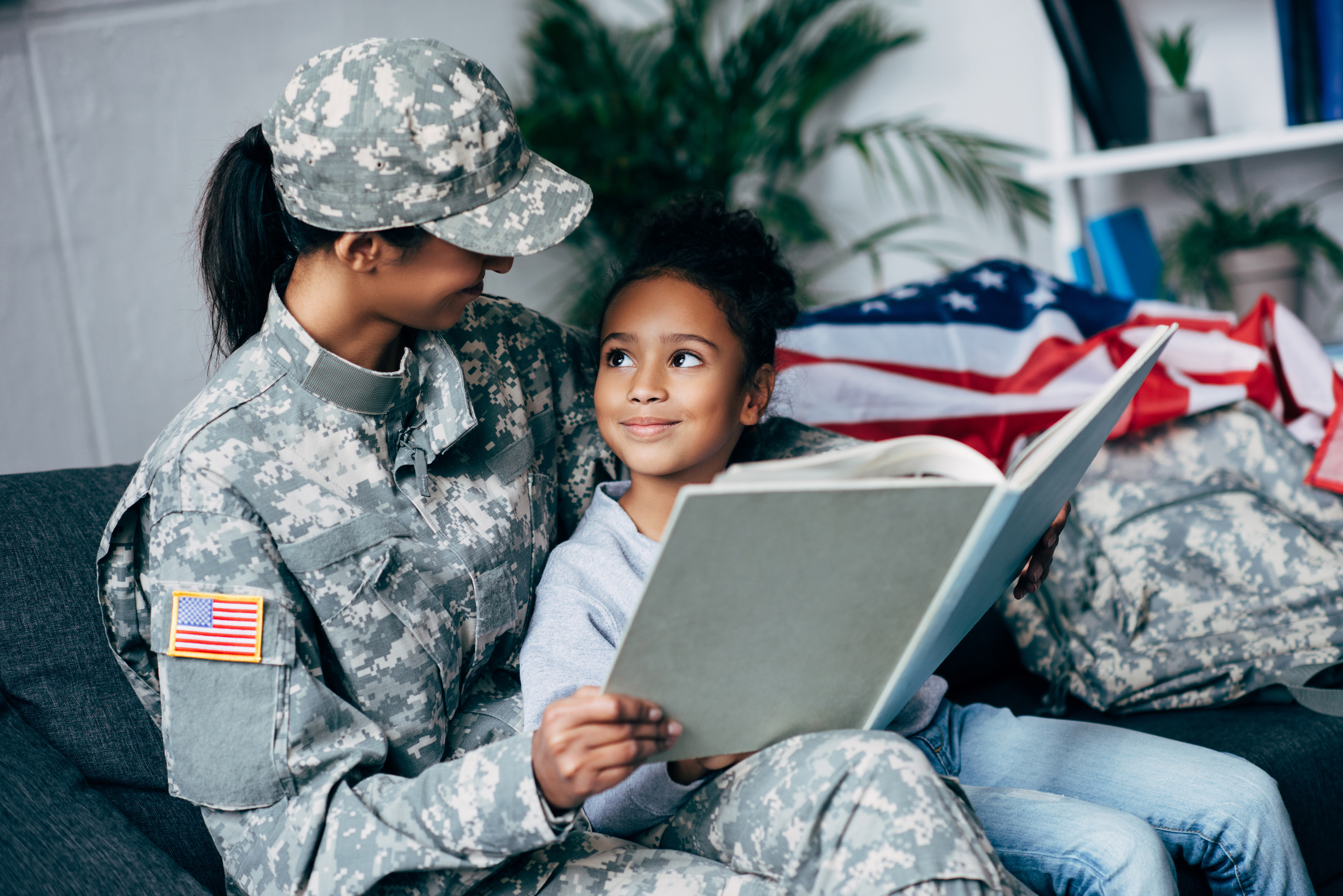 military woman reading to child