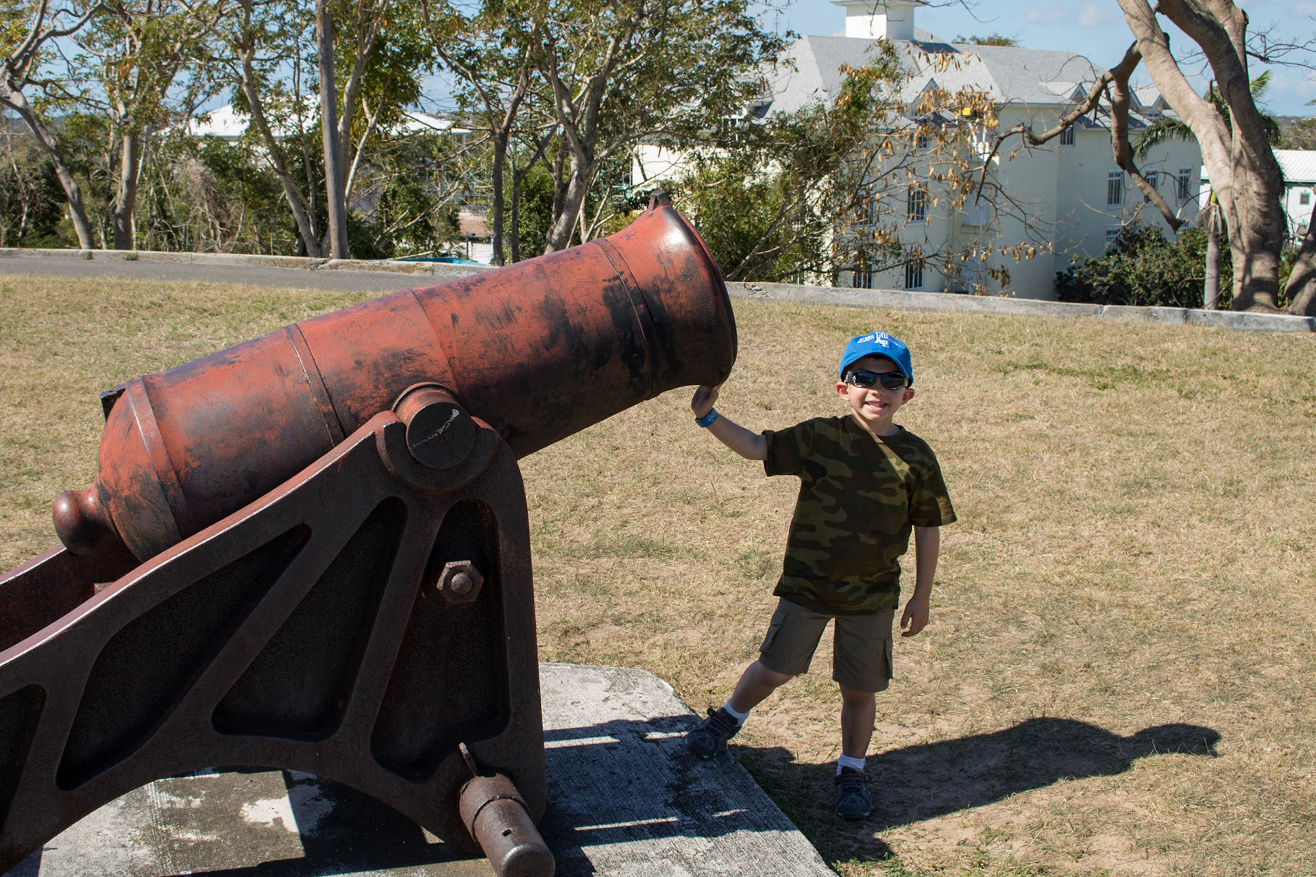 Daxton poses in front of a replica howitzer protecting Fort Fincastle in Nassau.