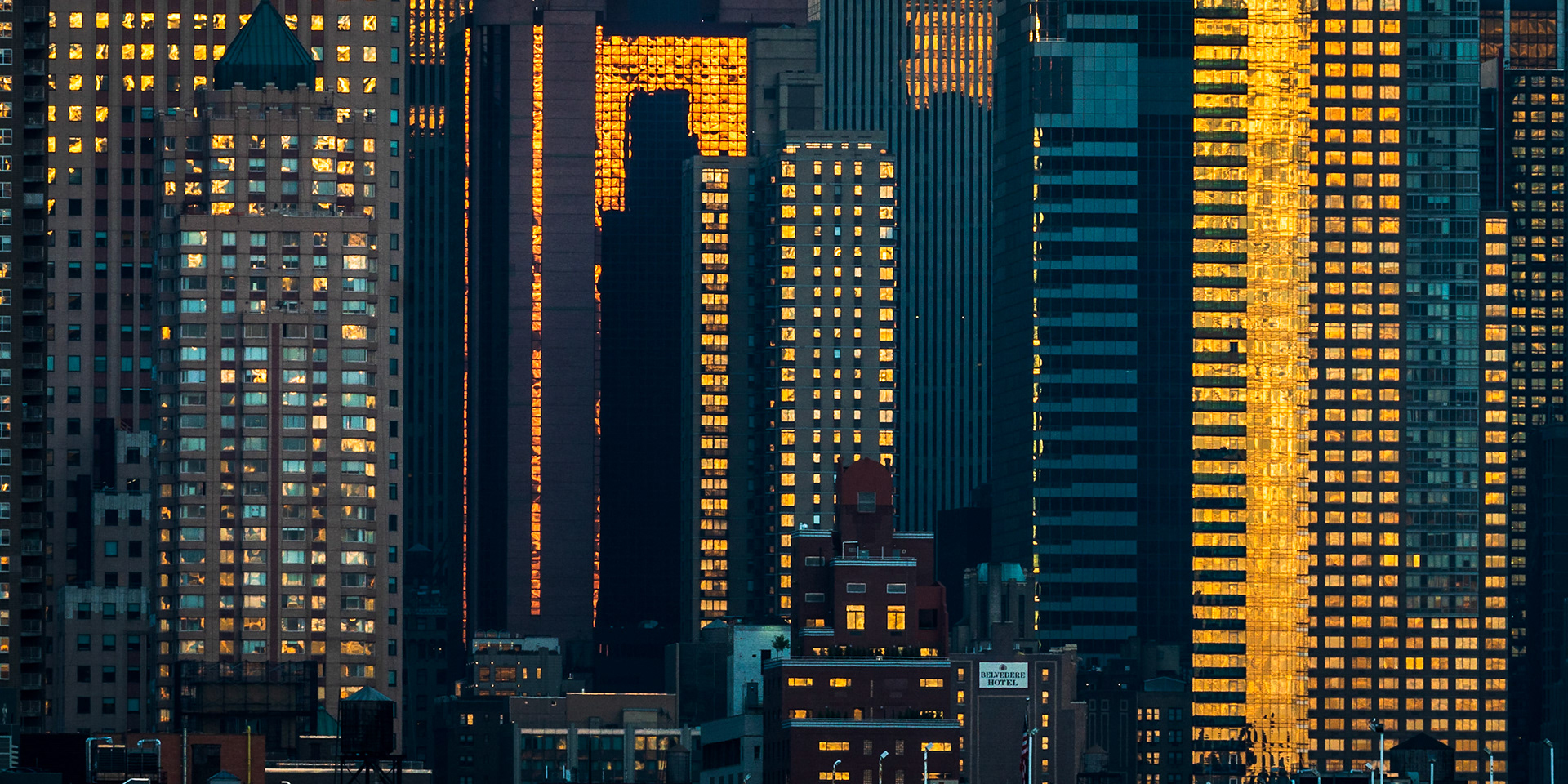 The towers of midtown Manhattan relfect the day's last light as the sun sets.
