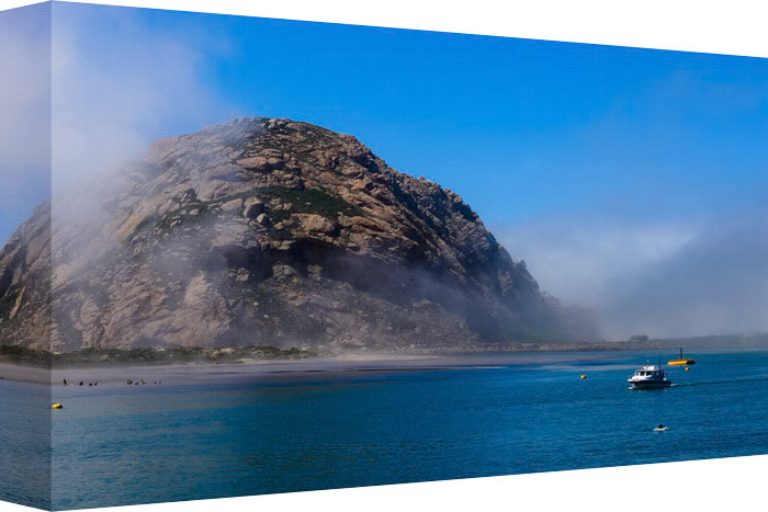 Just inside a bay this massive rock appears.  This rock provides landmark for a small harbor and is home to many birds and sea creatures, visible for miles on a clear day.