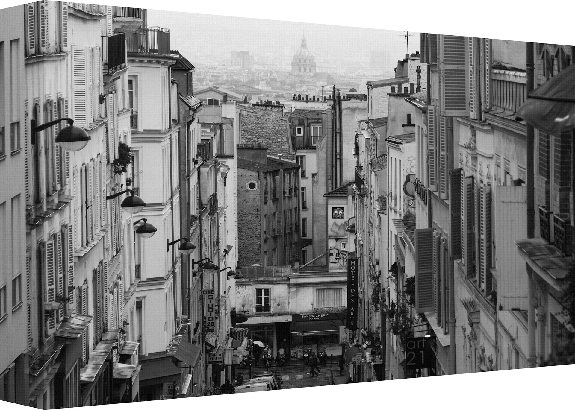 "City High" is a captivating monochromatic photograph that offers a bird's-eye view of an urban landscape. The image is composed with a keen eye for depth and perspective, leading the viewer's gaze down a narrow, bustling street flanked by tall buildings with classic architectural details. In the distance, the cityscape opens up to reveal an iconic domed structure that punctuates the skyline, adding a focal point of historical significance to the composition. The grayscale tones highlight textural contrasts and architectural forms, evoking a sense of nostalgia and timelessness. This artwork masterfully captures the essence of city life and its layered complexity.