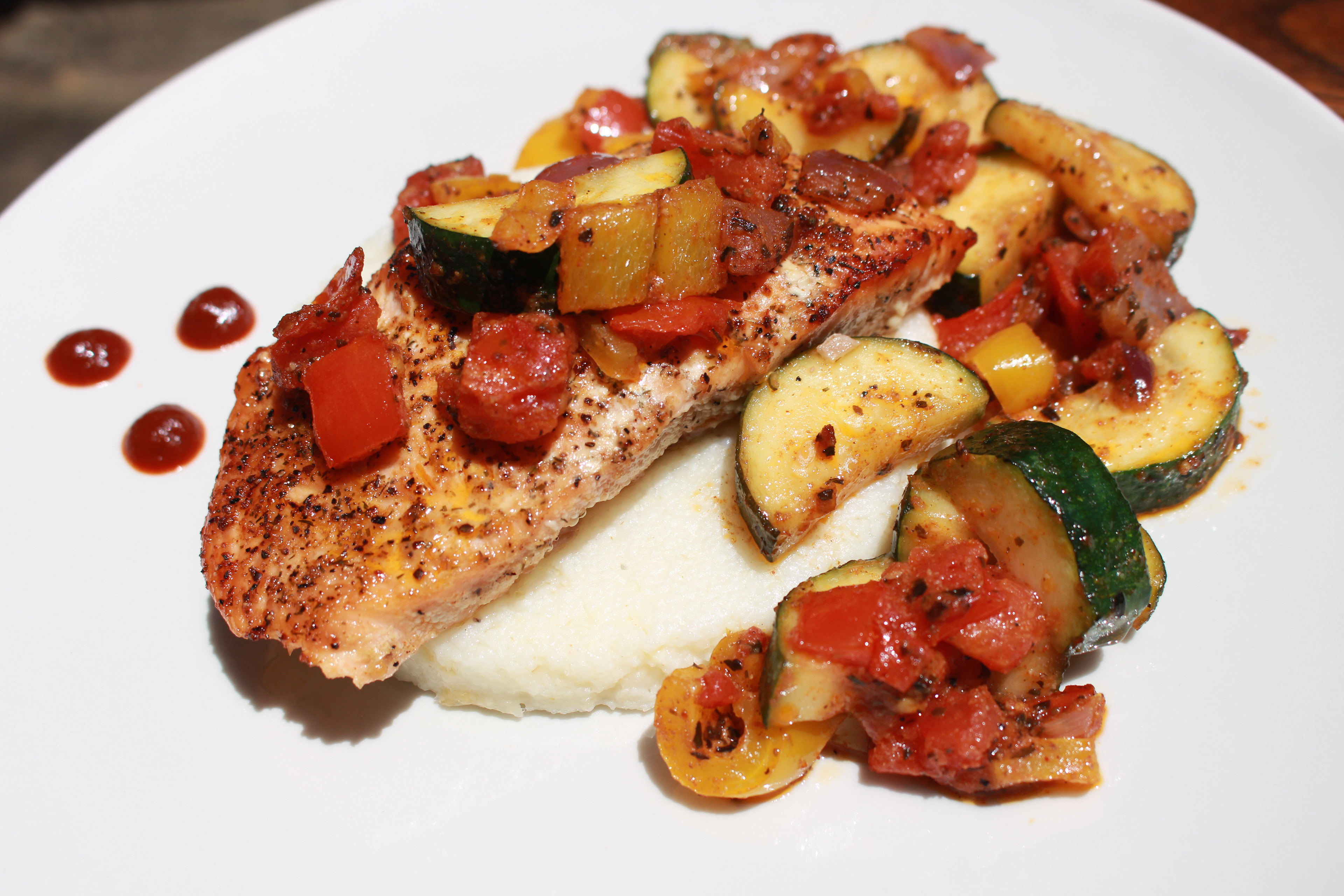 Cajun salmon over grit cakes