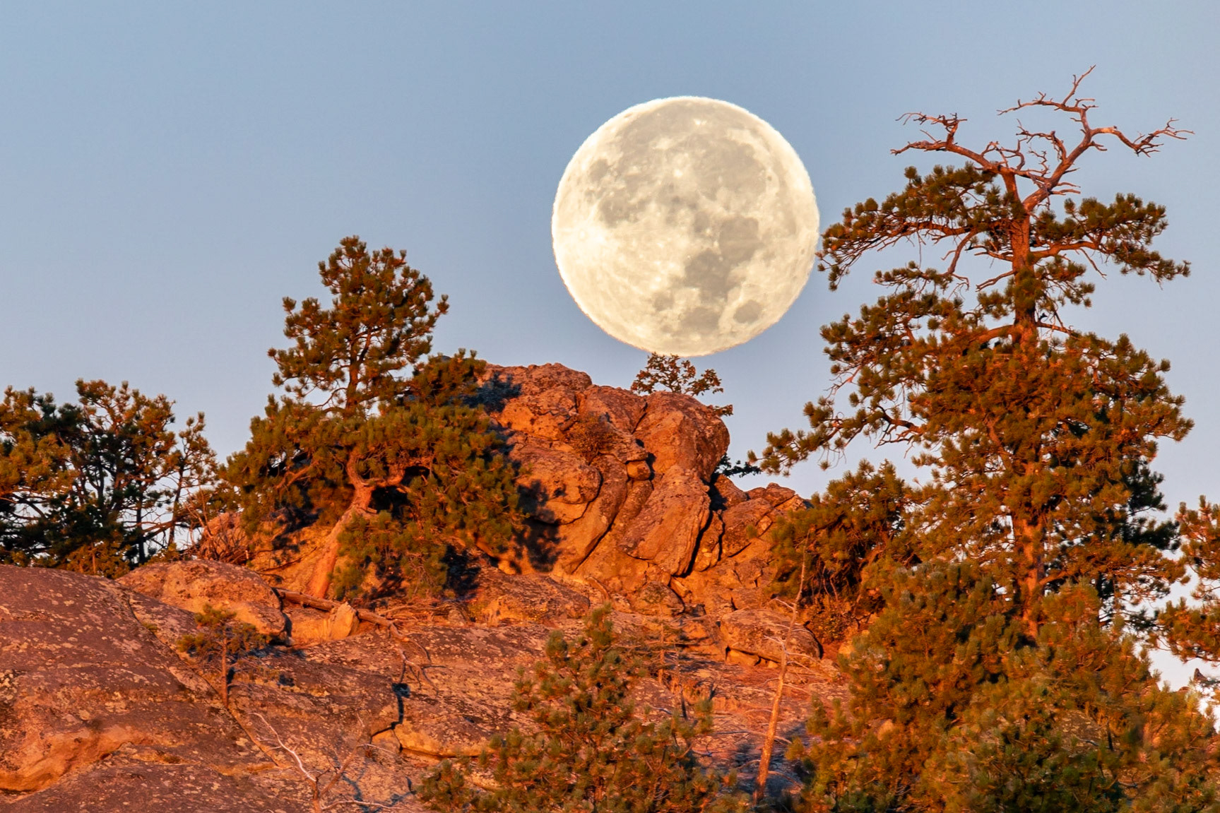 Harvest moonrise over rocks