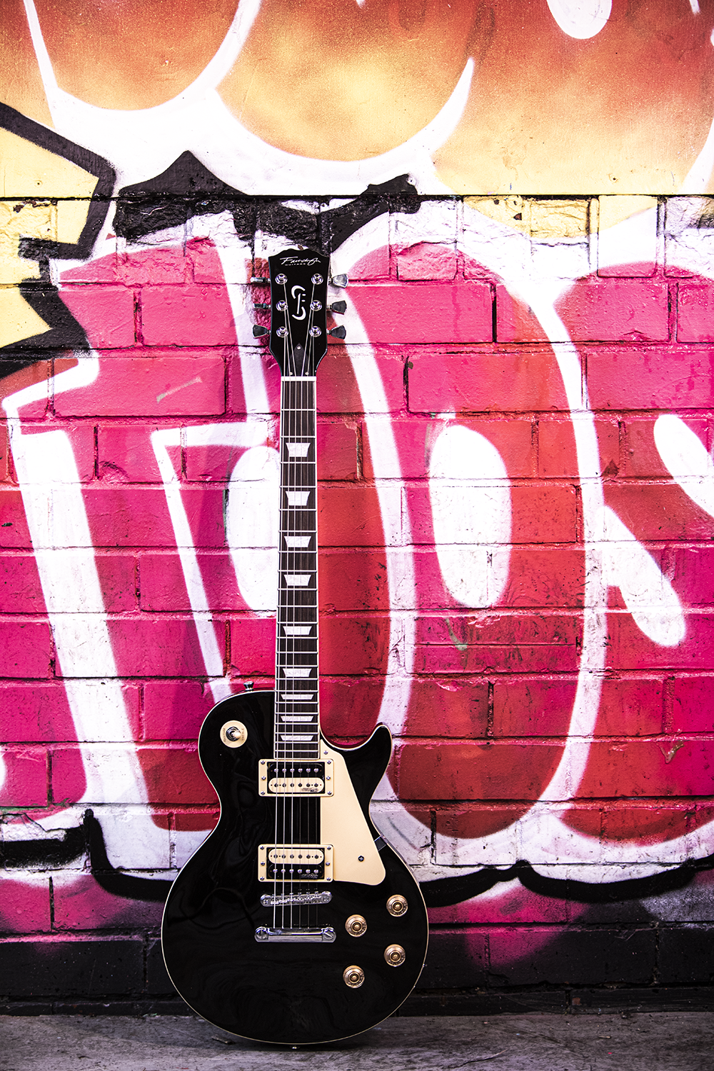 Fairclough Les Paul resting against a grafitii wall