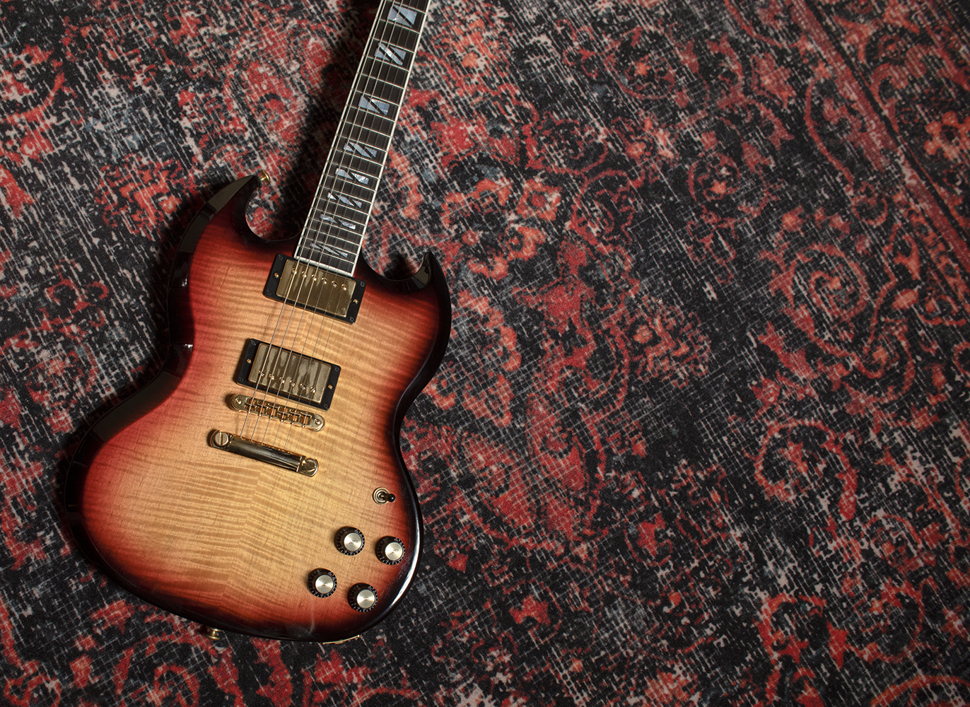 Gibson Les Paul supreme on floor with tab books