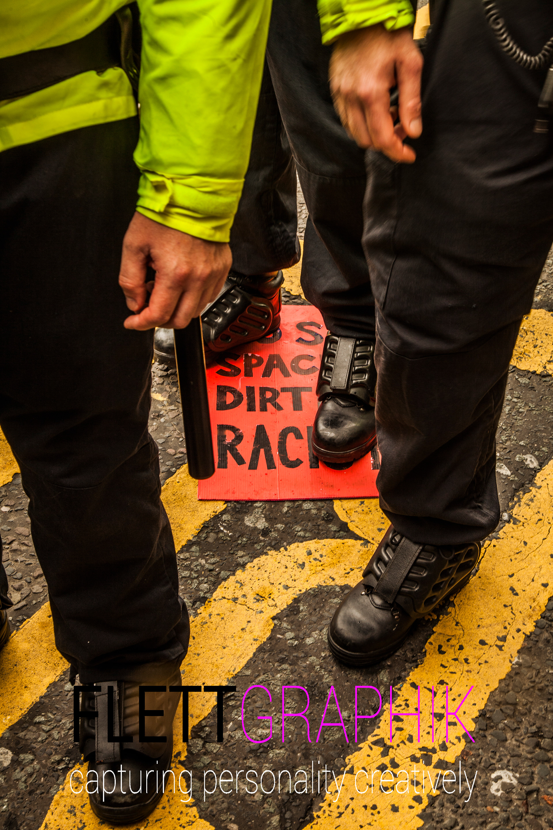 Police stand on anti racist sign