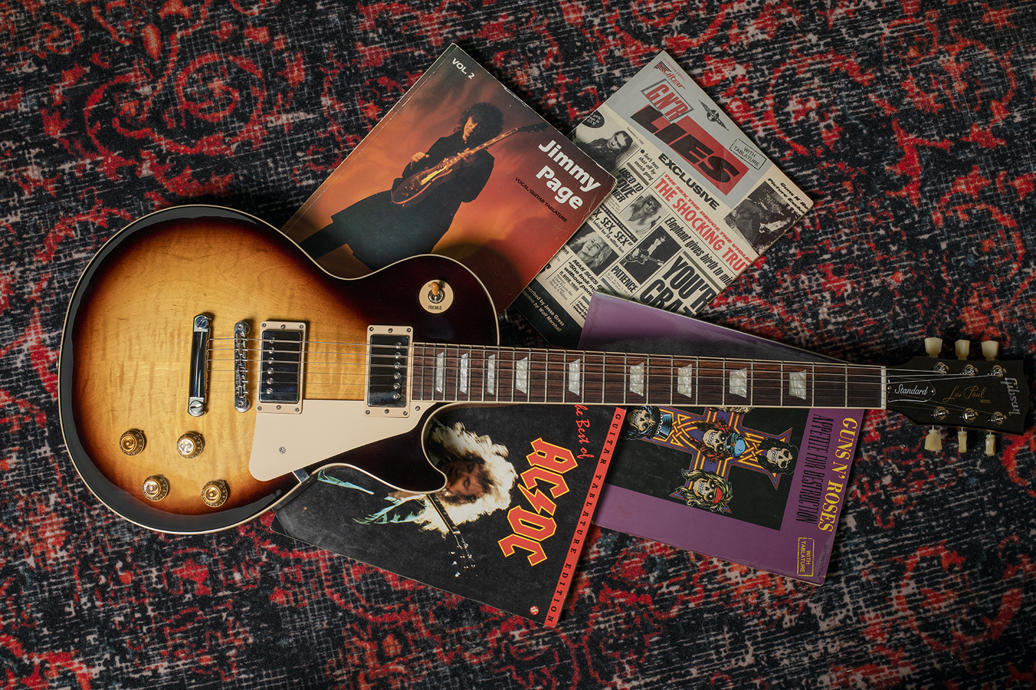 Gibson Les Paul supreme on floor with tab books